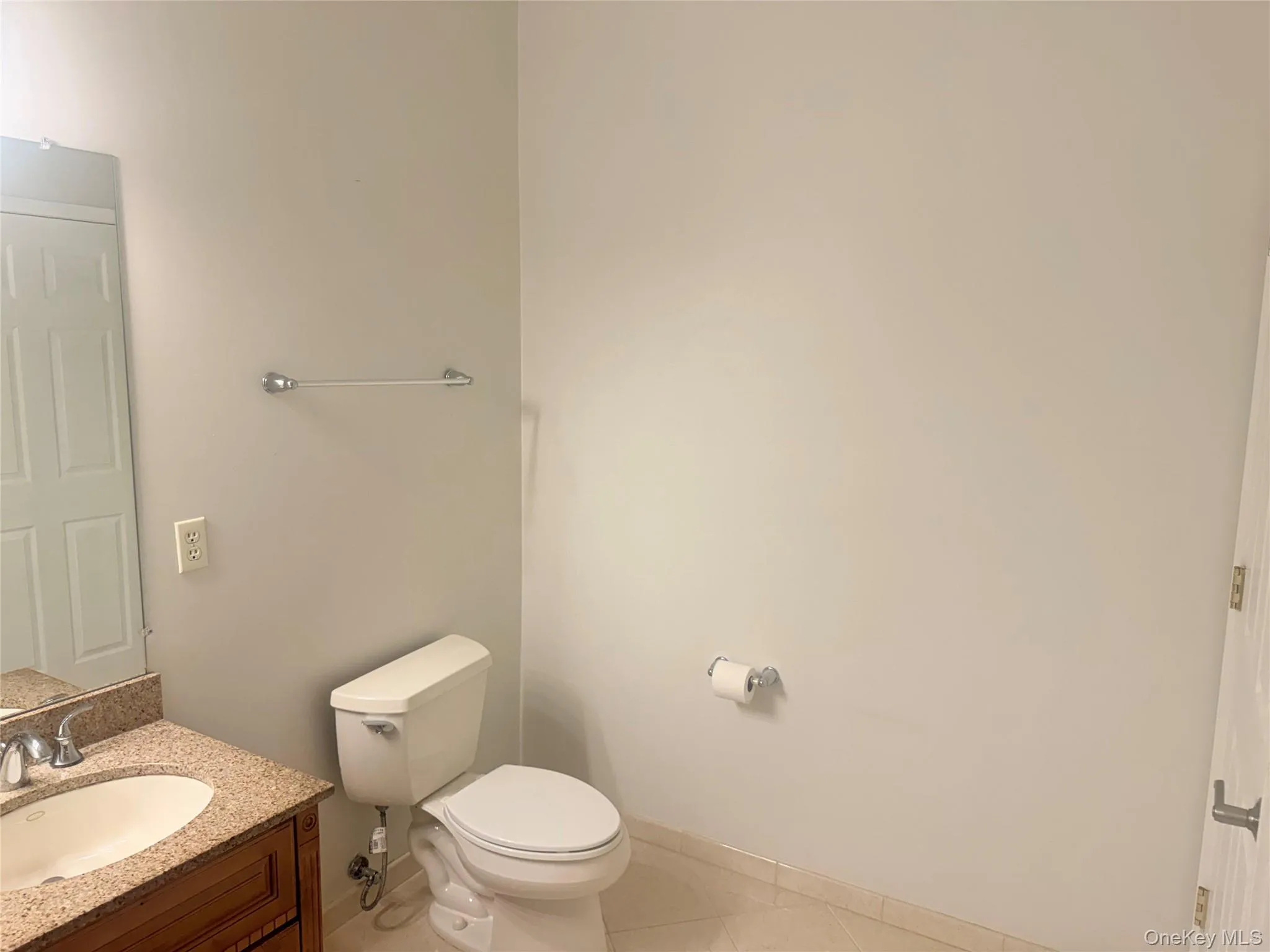 Bathroom featuring a vanity with a light-colored countertop, an undermount sink, and chrome fixtures Bathroom featuring a vanity with a light-colored countertop, an undermount sink, and chrome fixtures