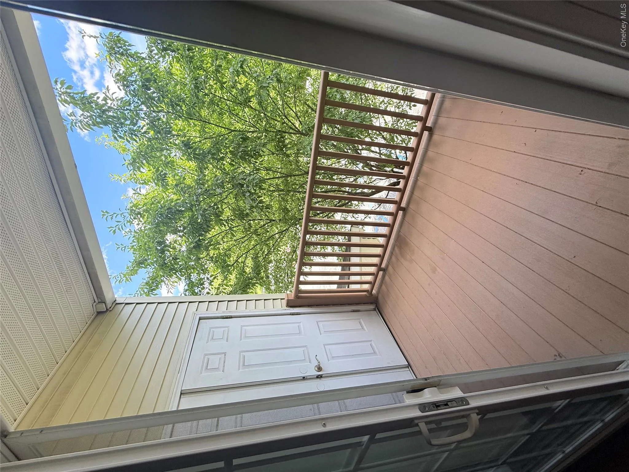 Private balcony with composite decking and wood railing Private balcony with composite decking and wood railing