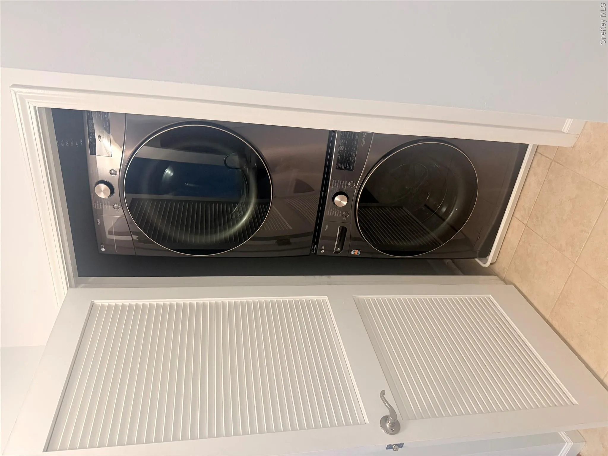 Stackable washer and dryer unit within a dedicated utility closet Stackable washer and dryer unit within a dedicated utility closet