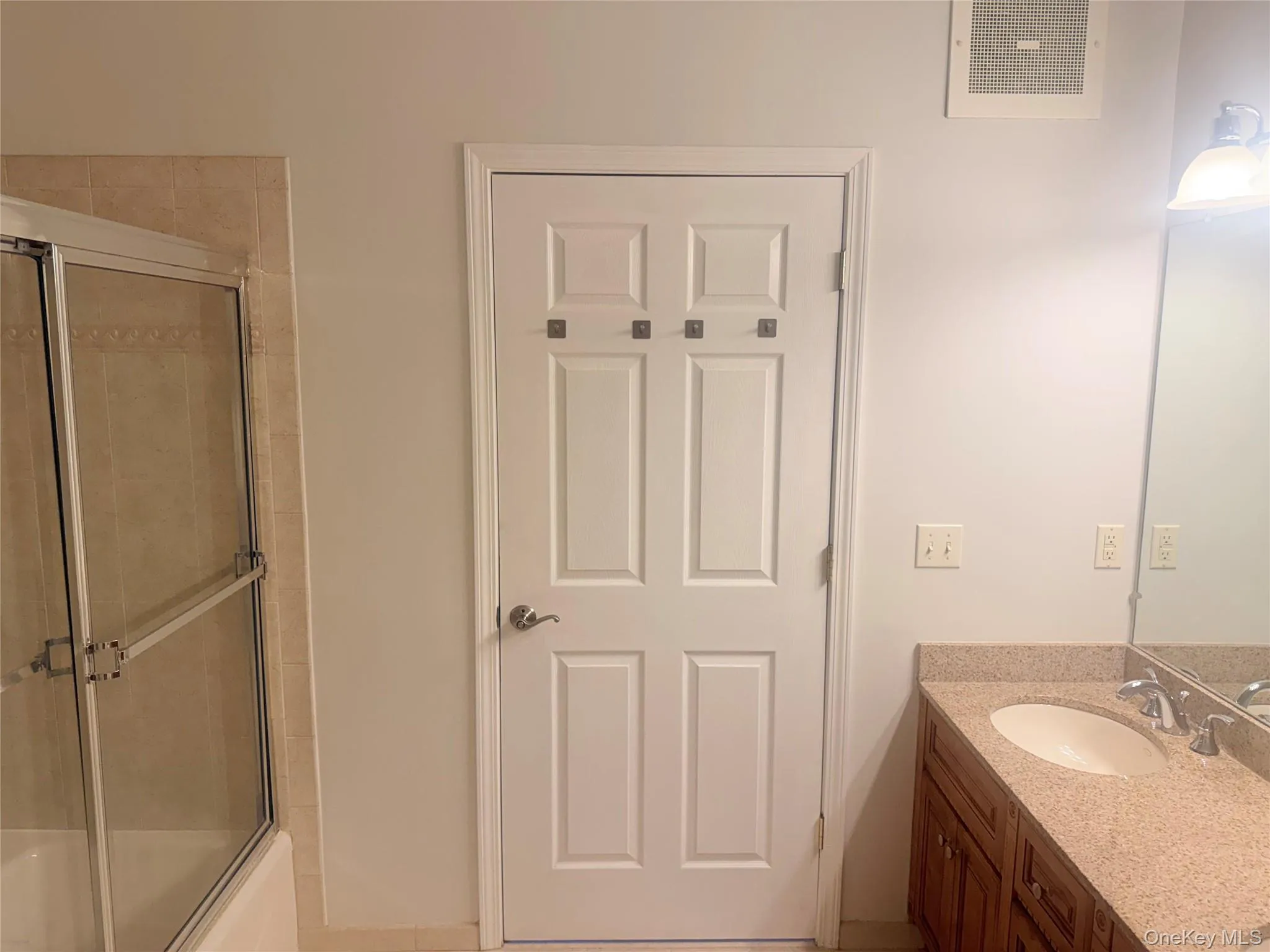 Bathroom vanity with a granite-style countertop, undermount sink, and dual-handle faucet Bathroom vanity with a granite-style countertop, undermount sink, and dual-handle faucet