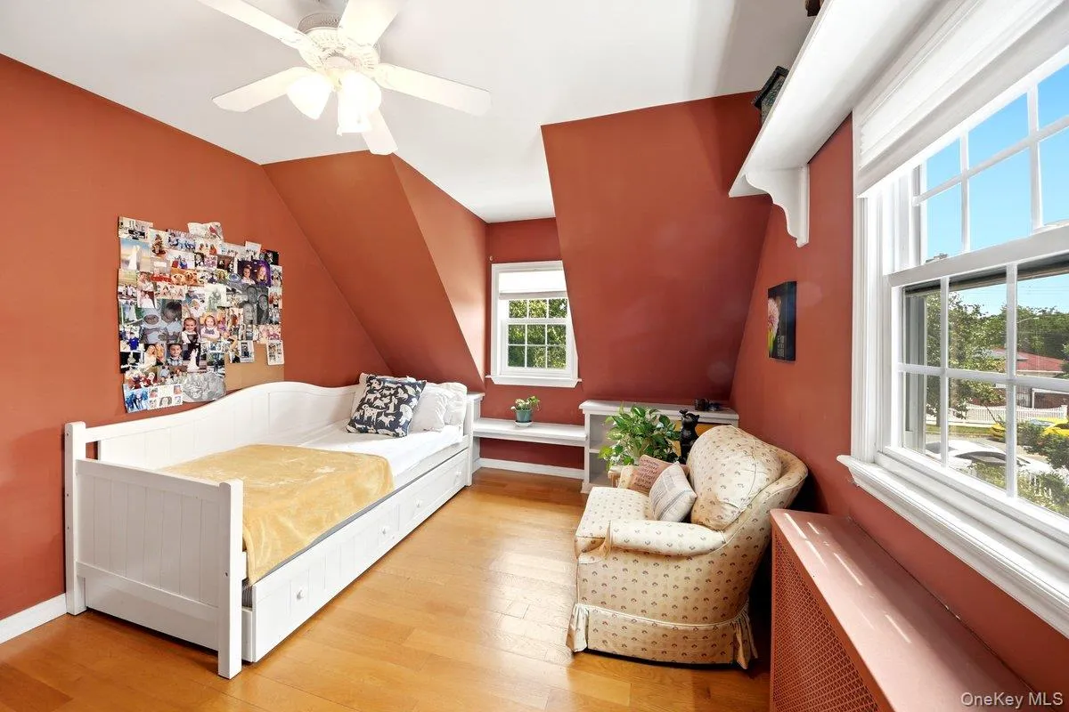 2nd floor Bedroom featuring sloped ceilings, hardwood flooring, and multiple windows 2nd floor Bedroom featuring sloped ceilings, hardwood flooring, and multiple windows