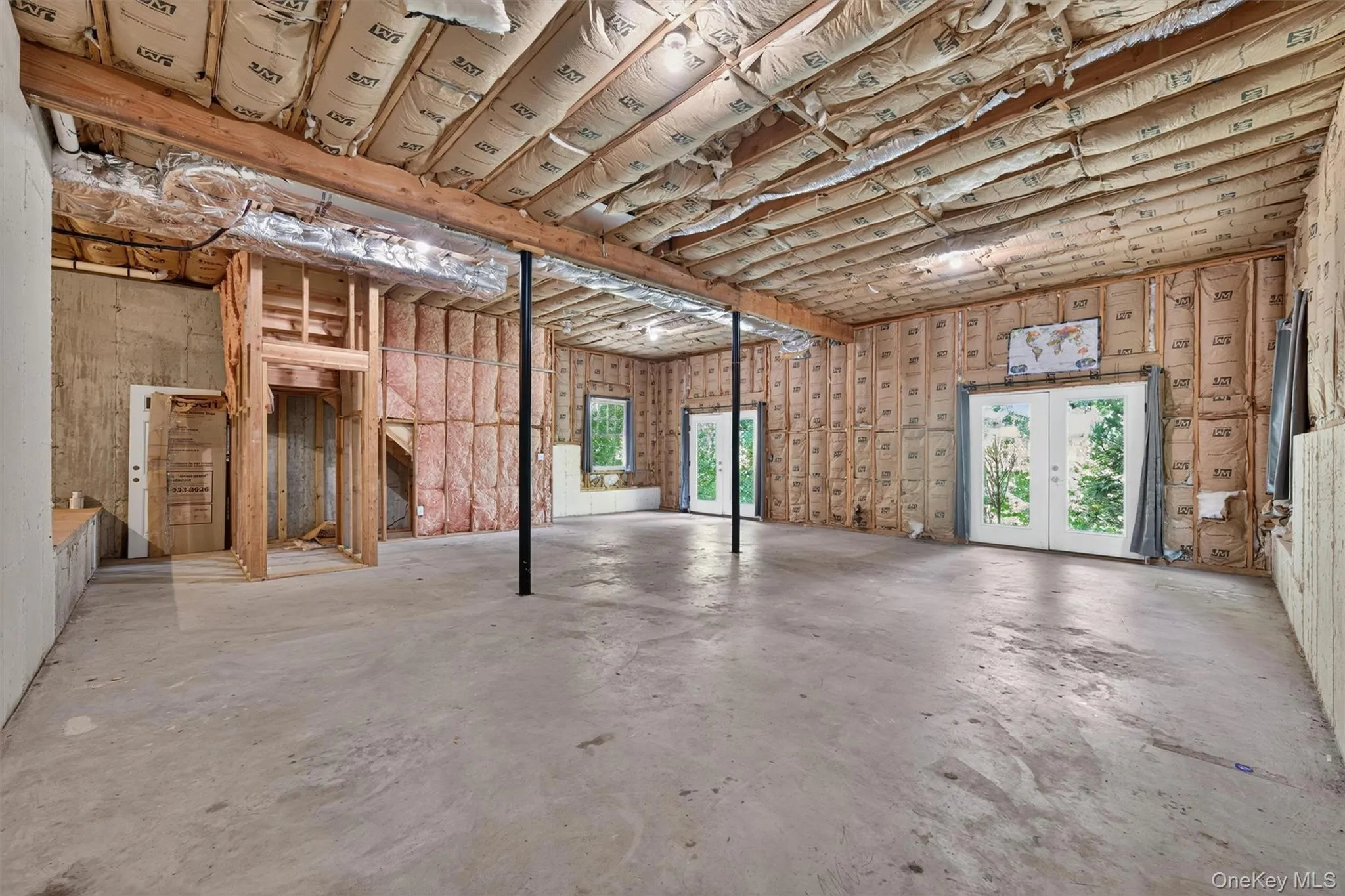 Large unfinished basement with high ceilings and French doors leading to the backyard, ready for your ideas to make it your own. Large unfinished basement with high ceilings and French doors leading to the backyard, ready for your ideas to make it your own.