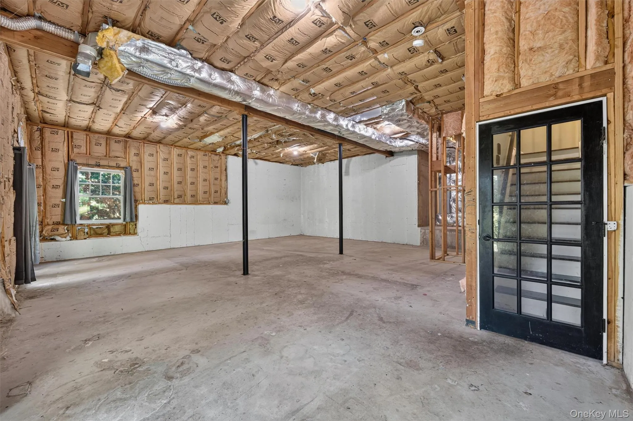 Bring your ideas for this unfinished large basement with French doors to yard. Bring your ideas for this unfinished large basement with French doors to yard.