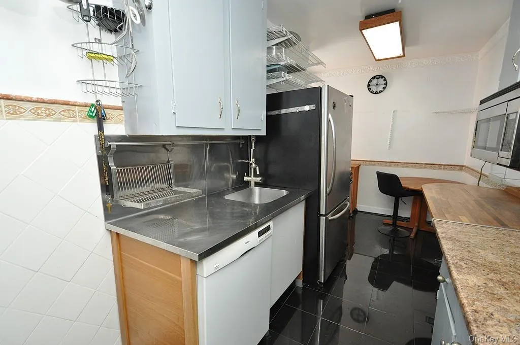 Eat-in-Kitchen has a range, dishwasher, stainless steel refrigerator and stainless steel microwave. There is a window for natural light and fresh air. Eat-in-Kitchen has a range, dishwasher, stainless steel refrigerator and stainless steel microwave. There is a window for natural light and fresh air.