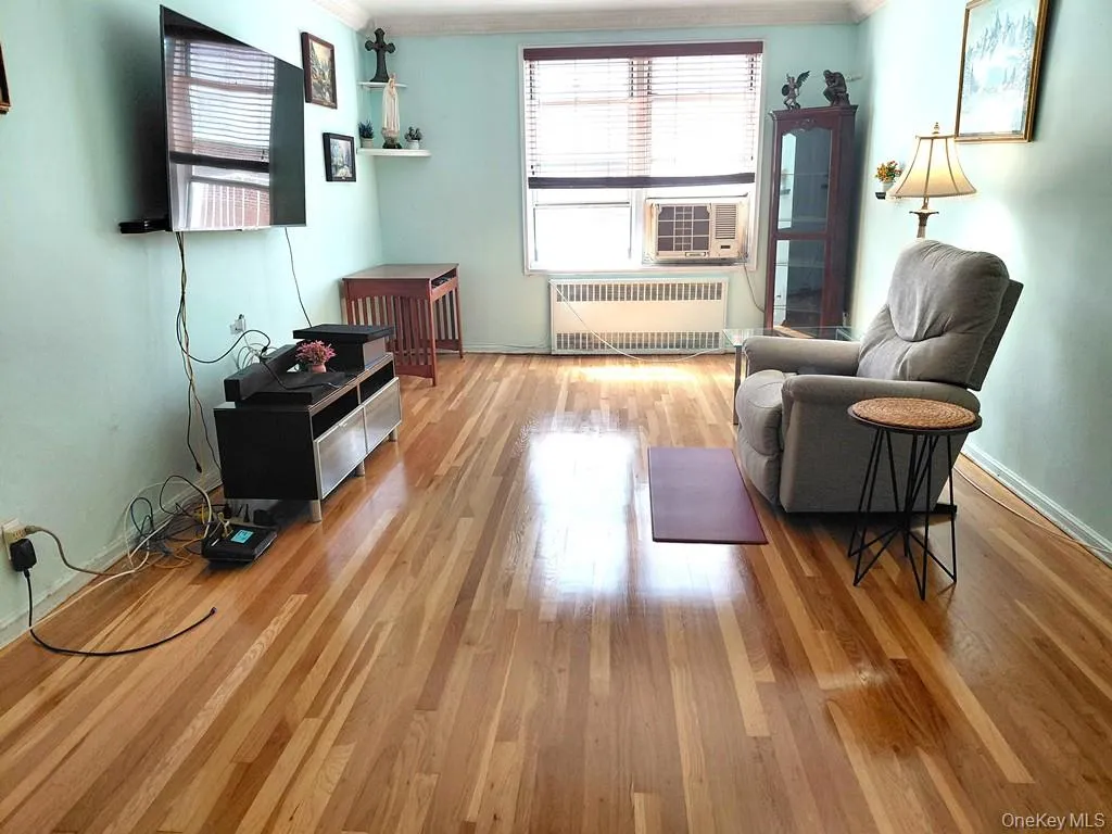 The bright and airy living room opens to the Dining foyer and has covered hardwood floors. The bright and airy living room opens to the Dining foyer and has covered hardwood floors.