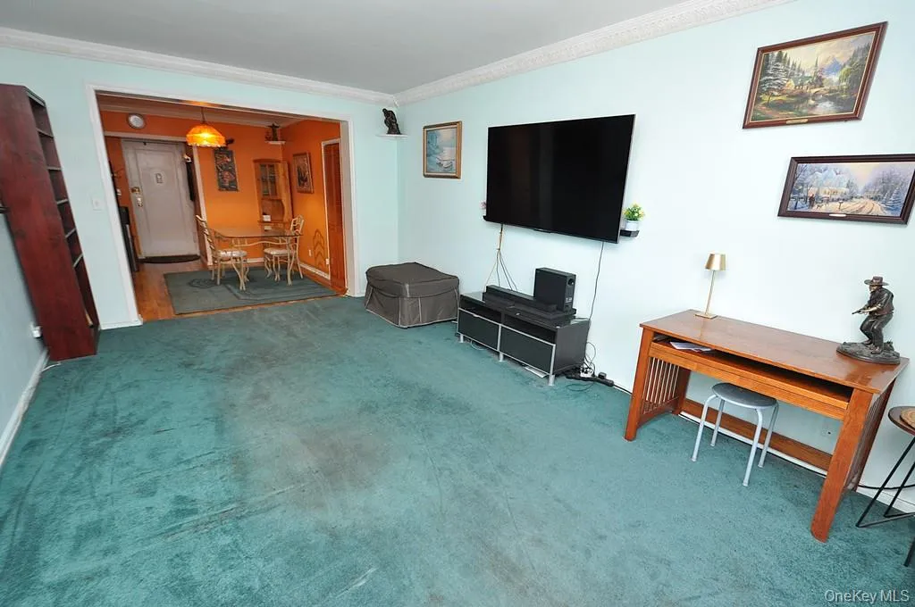 The bright and airy living room opens to the Dining foyer and has covered hardwood floors. The bright and airy living room opens to the Dining foyer and has covered hardwood floors.