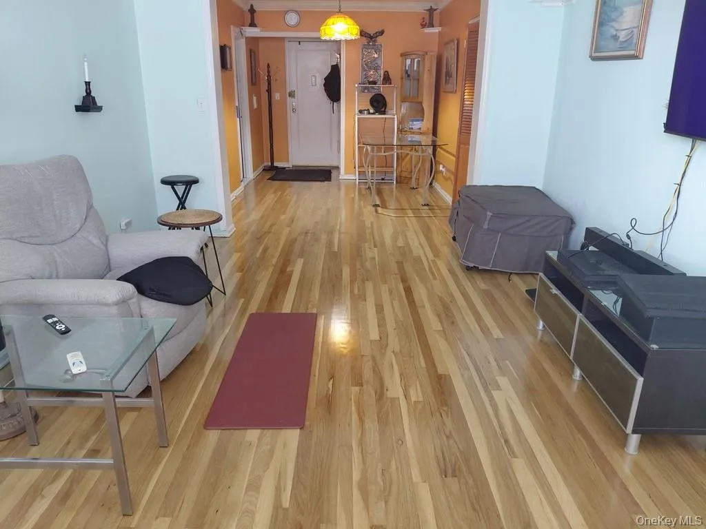 The bright and airy living room opens to the Dining foyer and has covered hardwood floors. The bright and airy living room opens to the Dining foyer and has covered hardwood floors.