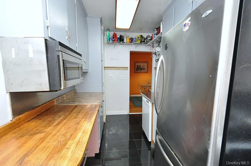 Eat-in-Kitchen has a range, dishwasher, stainless steel refrigerator and stainless steel microwave. There is a window for natural light and fresh air. Eat-in-Kitchen has a range, dishwasher, stainless steel refrigerator and stainless steel microwave. There is a window for natural light and fresh air.