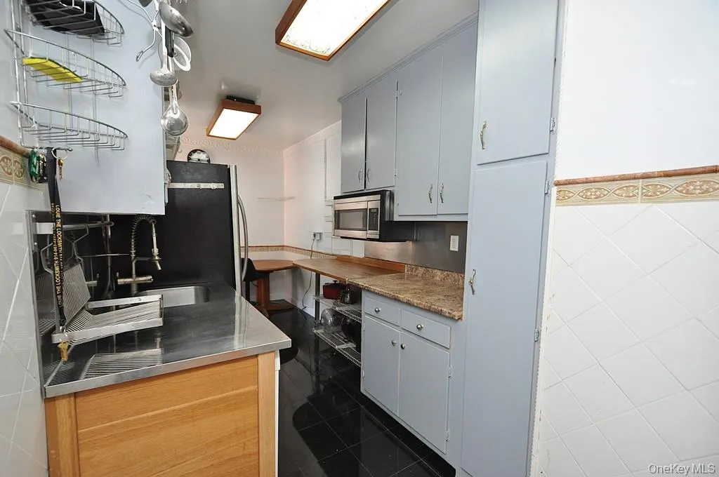Eat-in-Kitchen has a range, dishwasher, stainless steel refrigerator and stainless steel microwave. There is a window for natural light and fresh air. Eat-in-Kitchen has a range, dishwasher, stainless steel refrigerator and stainless steel microwave. There is a window for natural light and fresh air.
