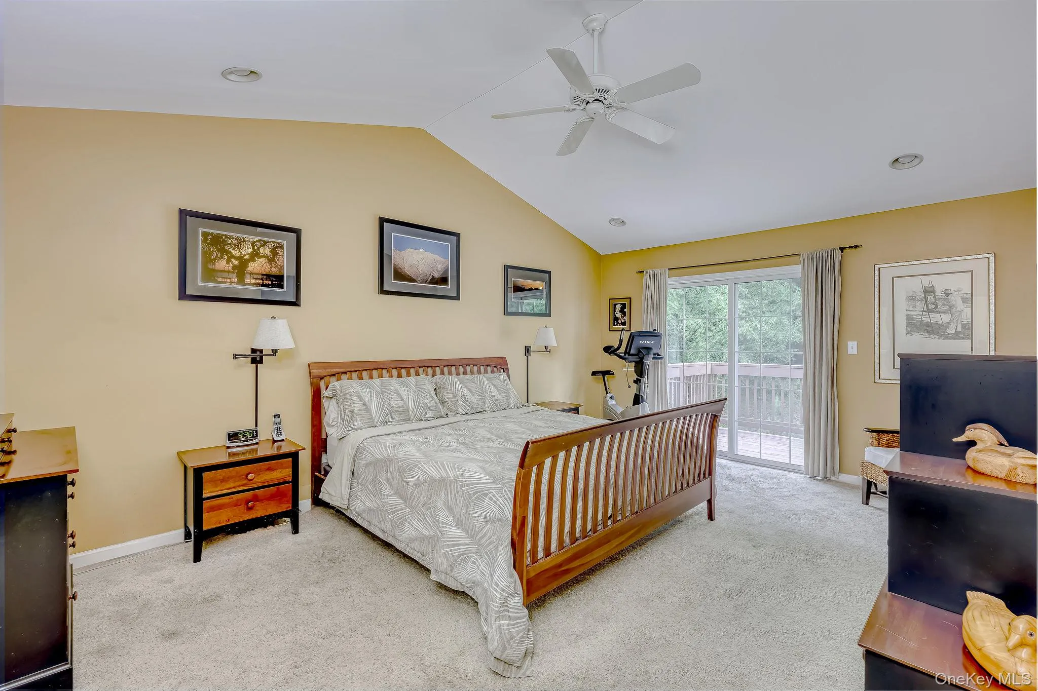 Primary bedroom with cathedral ceiling, recessed lighting and fan fixture. Unique second deck off bedroom. Primary bedroom with cathedral ceiling, recessed lighting and fan fixture. Unique second deck off bedroom.