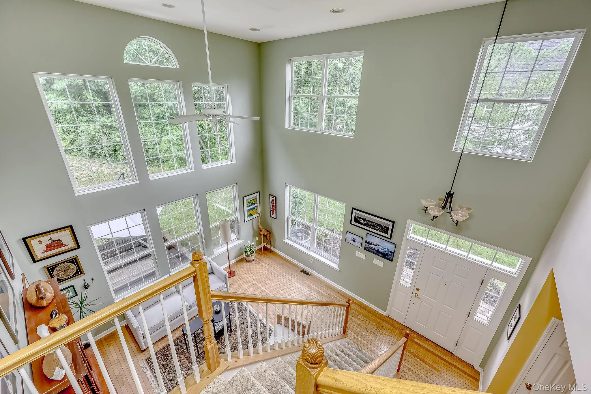 Two story living room with hardwood floors. Walls of glass lets in lots of natural light. Two story living room with hardwood floors. Walls of glass lets in lots of natural light.