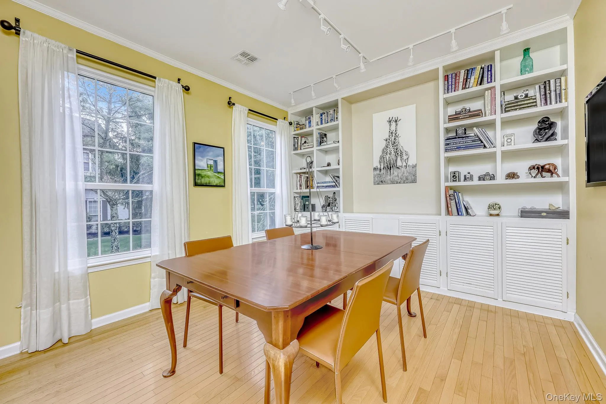 Formal dining room with track lighting and custom built cabinetry Formal dining room with track lighting and custom built cabinetry