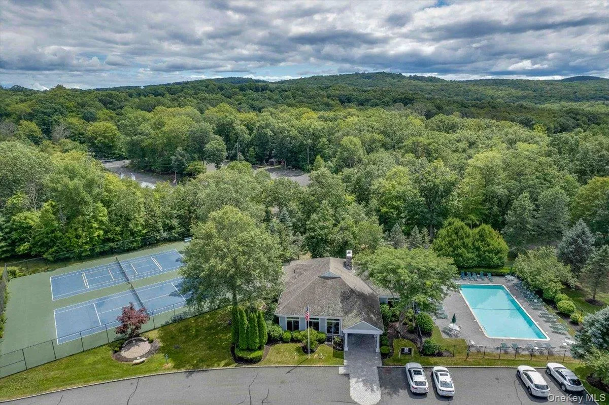 Aerial view of clubhouse, pool and tennis courts Aerial view of clubhouse, pool and tennis courts