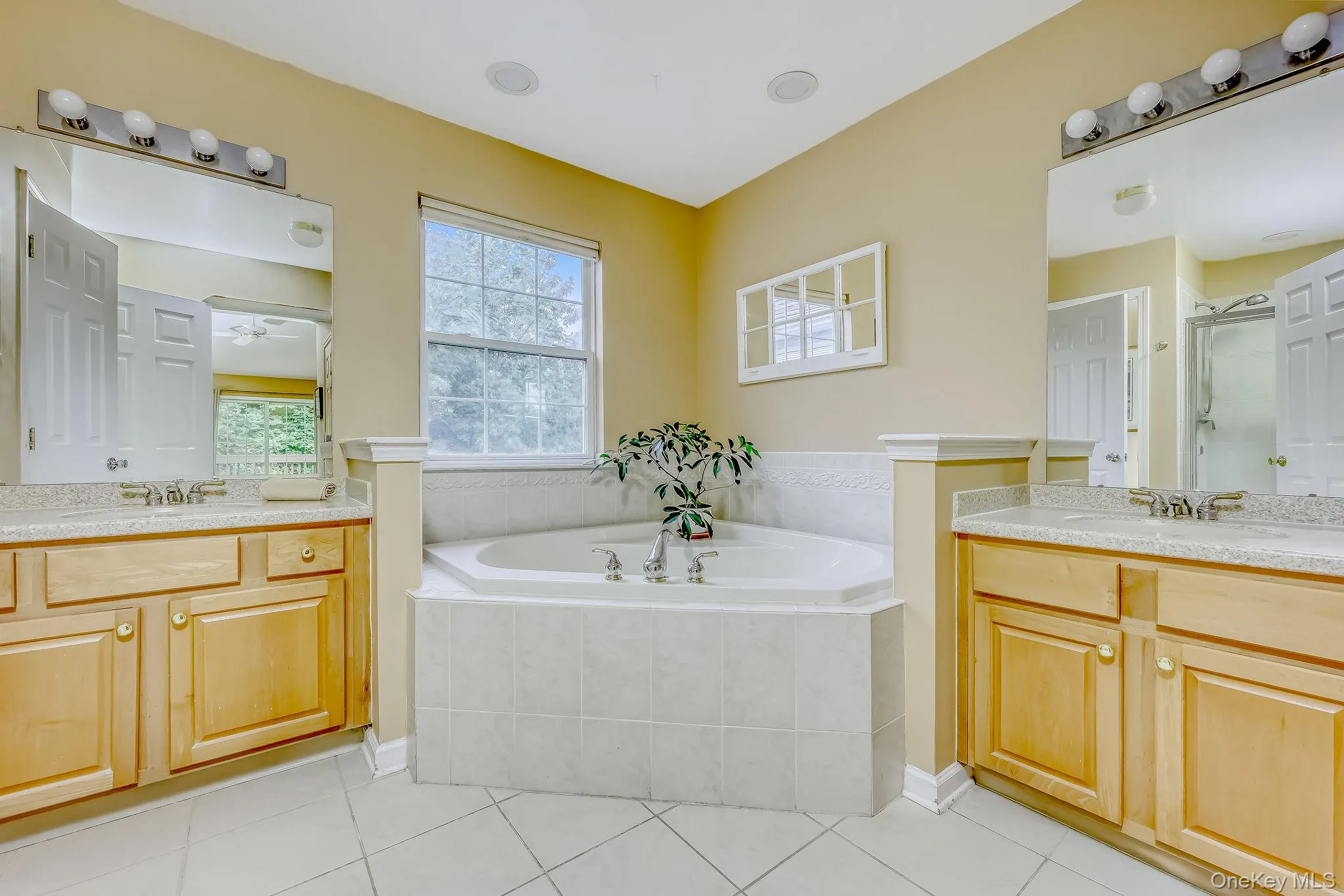 Ensuite bathroom with jacuzzi style tub and two vanities Ensuite bathroom with jacuzzi style tub and two vanities
