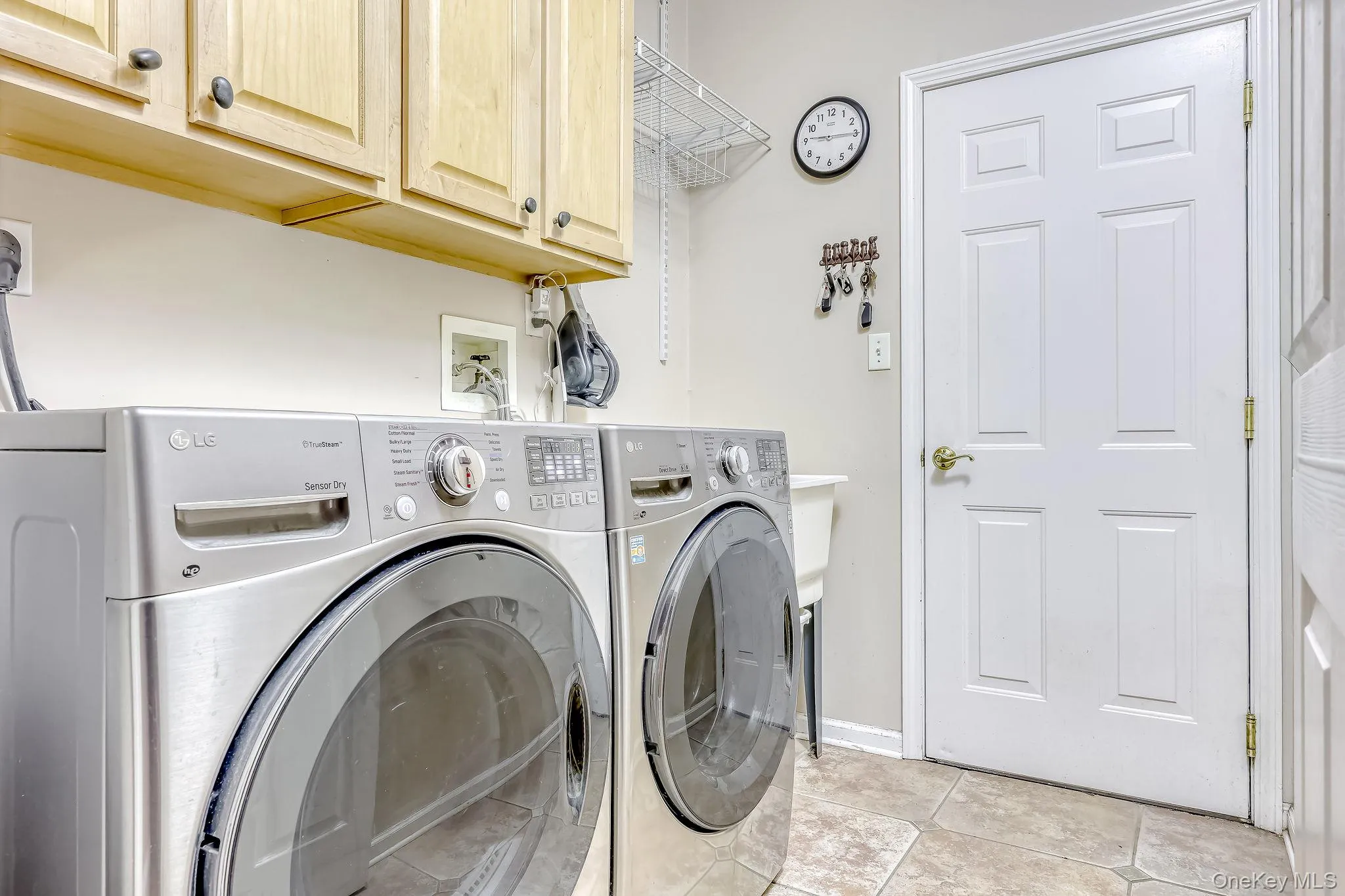 Laundry room with front loading washer and dryer. Slop sink. Laundry room with front loading washer and dryer. Slop sink.