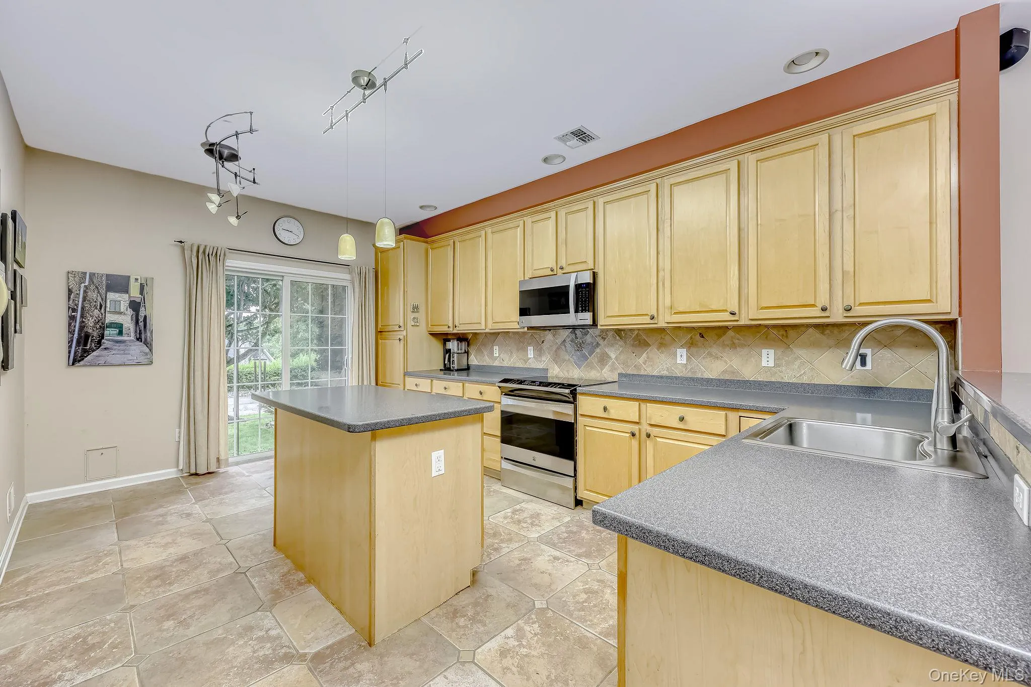 Tuscan style kitchen with sliders leading to a perfect spot for birdwatching or herb gardening. Tuscan style kitchen with sliders leading to a perfect spot for birdwatching or herb gardening.
