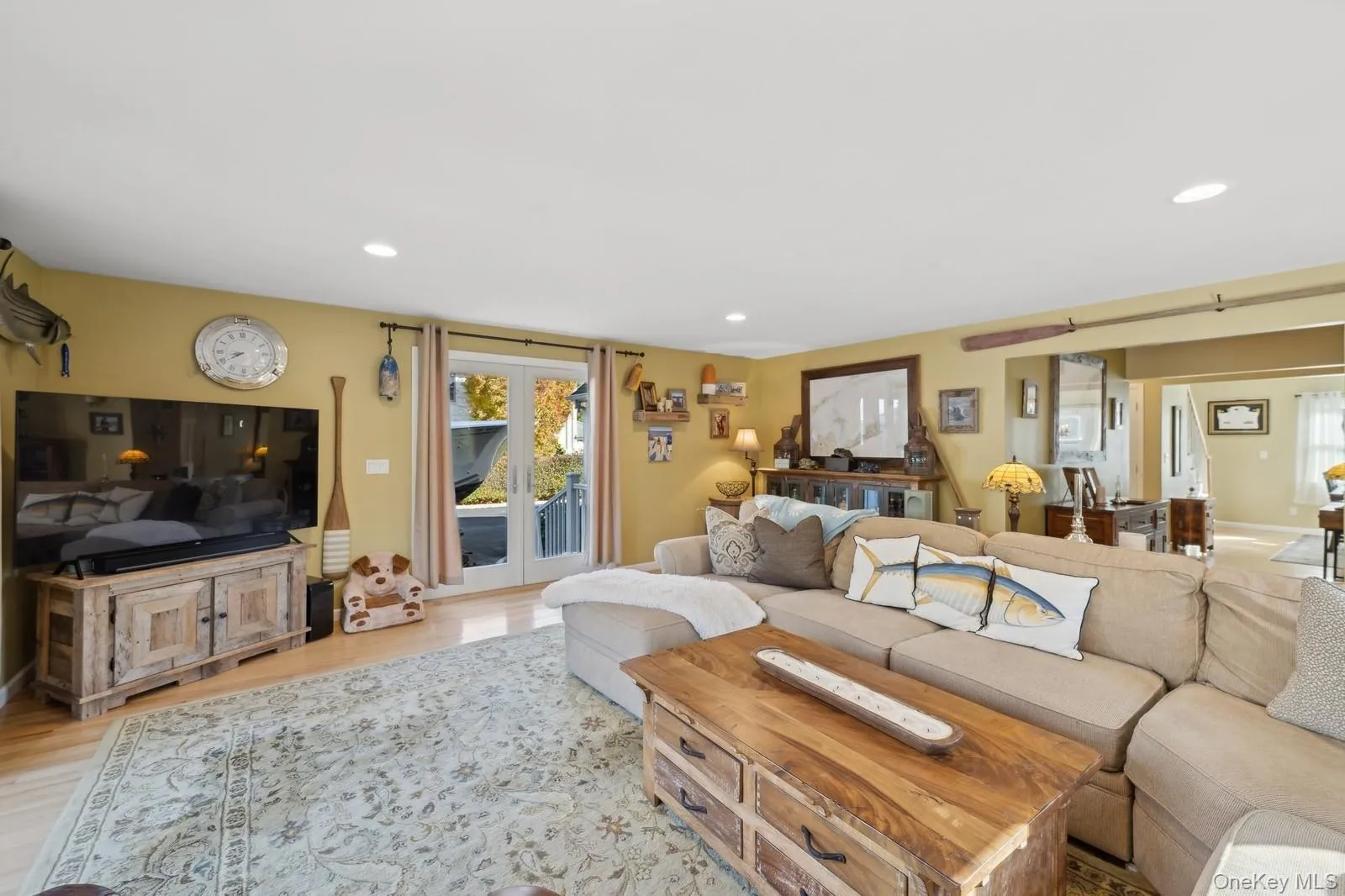 Living room with light hardwood / wood-style flooring and french doors Living room with light hardwood / wood-style flooring and french doors