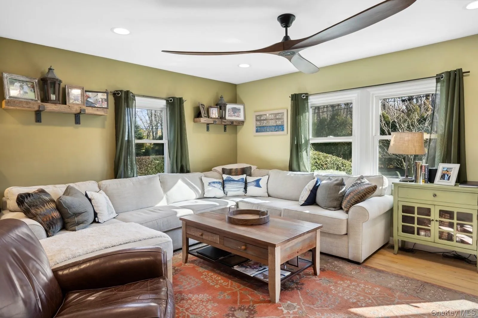 Living room with light wood-type flooring, a wealth of natural light, and ceiling fan Living room with light wood-type flooring, a wealth of natural light, and ceiling fan