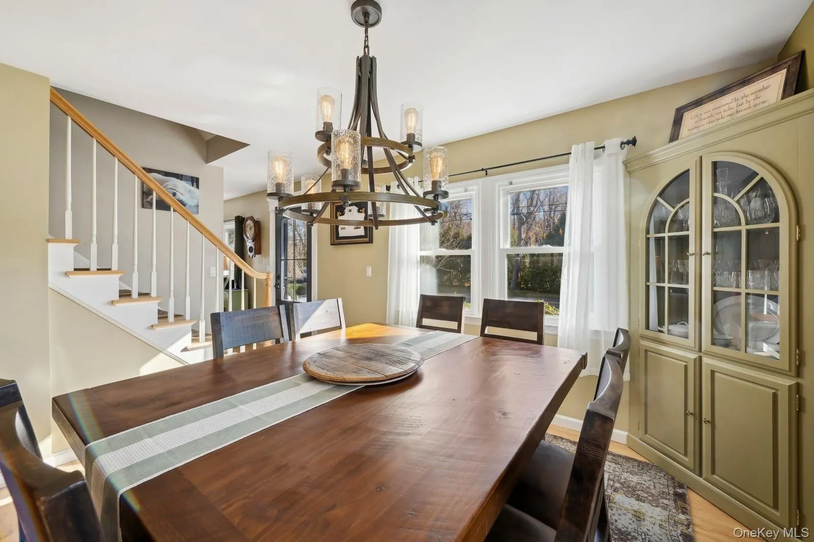 Dining space featuring light hardwood / wood-style floors and a chandelier Dining space featuring light hardwood / wood-style floors and a chandelier