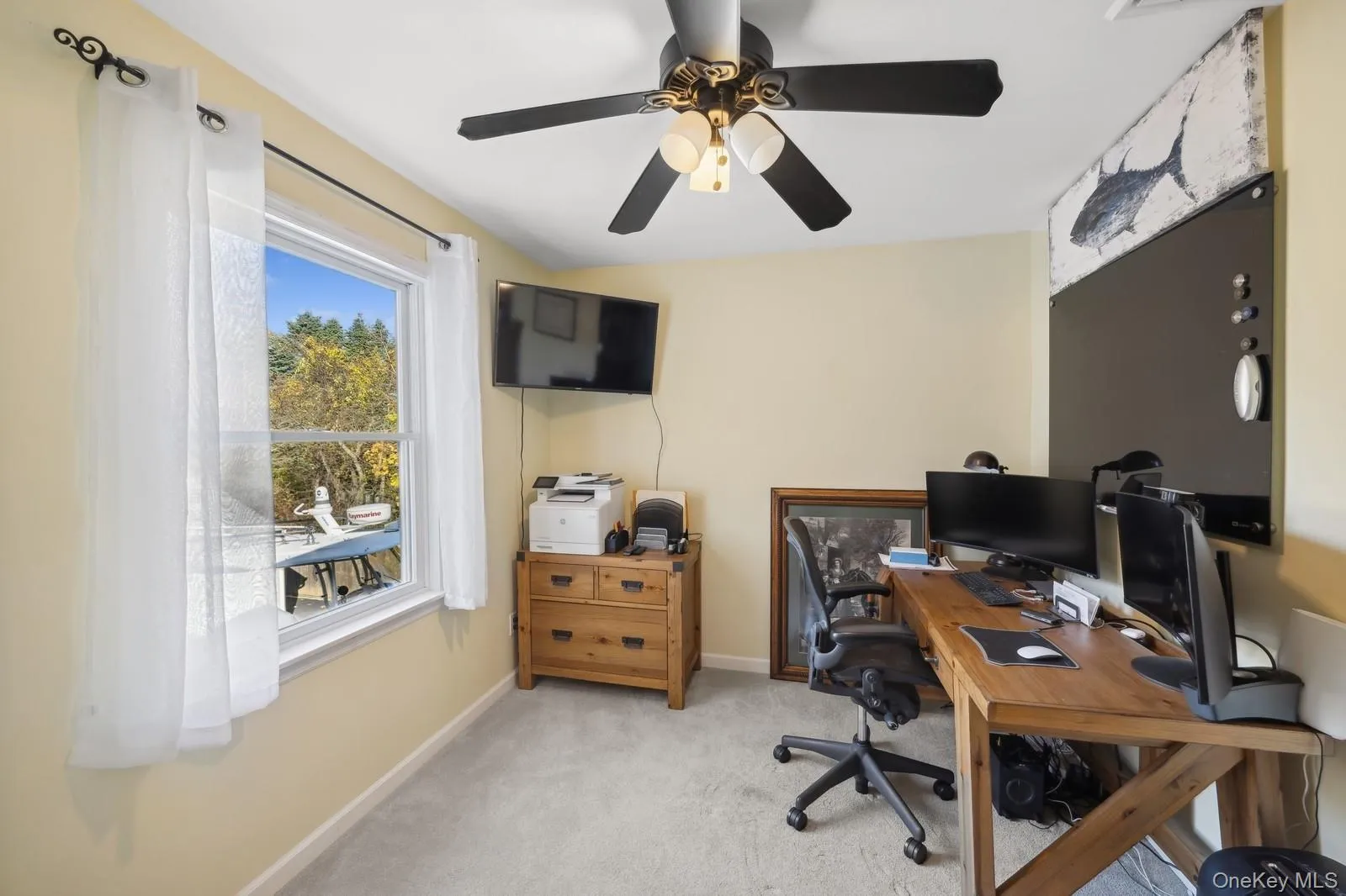 Home office with light carpet and ceiling fan Home office with light carpet and ceiling fan