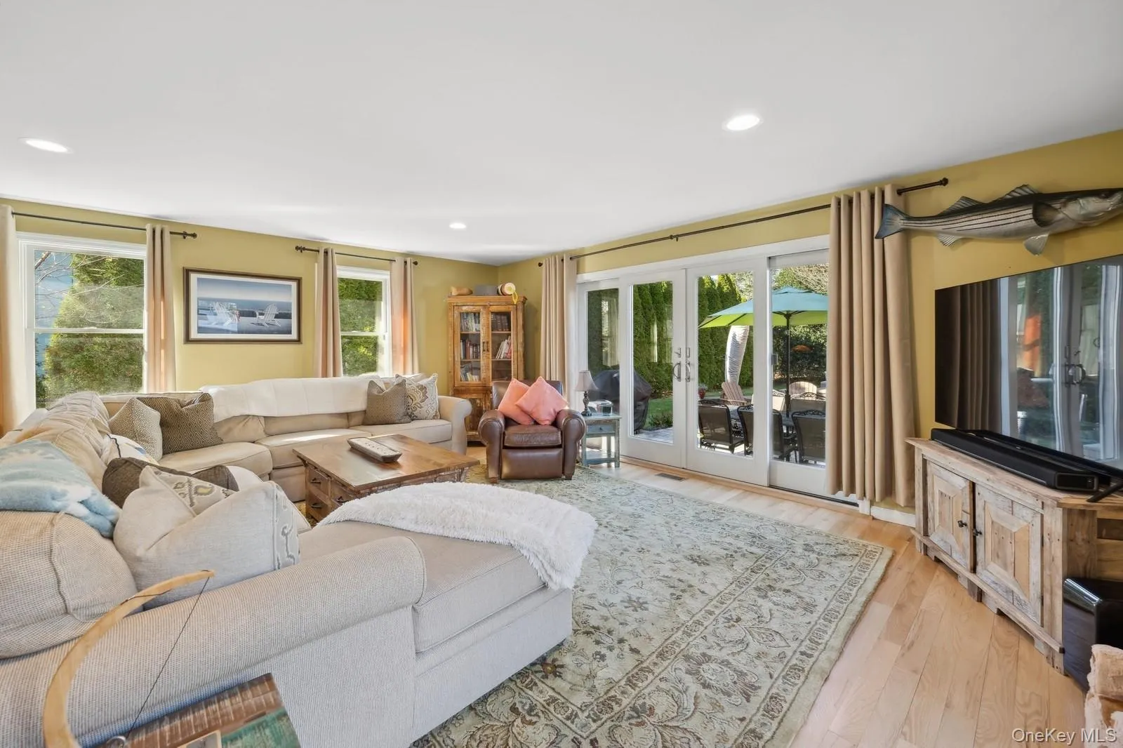 Living room with french doors and light hardwood / wood-style floors Living room with french doors and light hardwood / wood-style floors