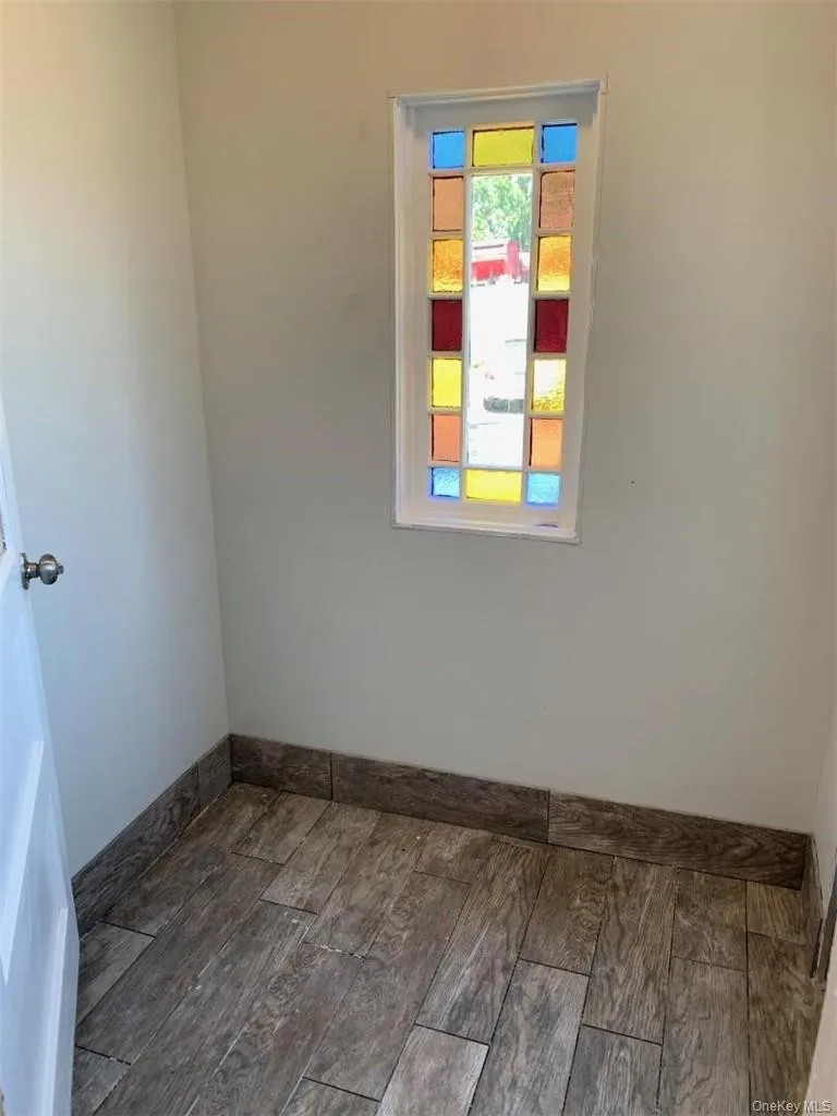 Entry foyer from rear of house with wood like vinyl tile flooring Entry foyer from rear of house with wood like vinyl tile flooring