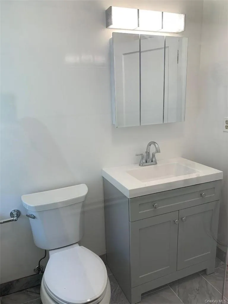 Pretty updated ceramic tile bathroom with a spacious shower stall Pretty updated ceramic tile bathroom with a spacious shower stall