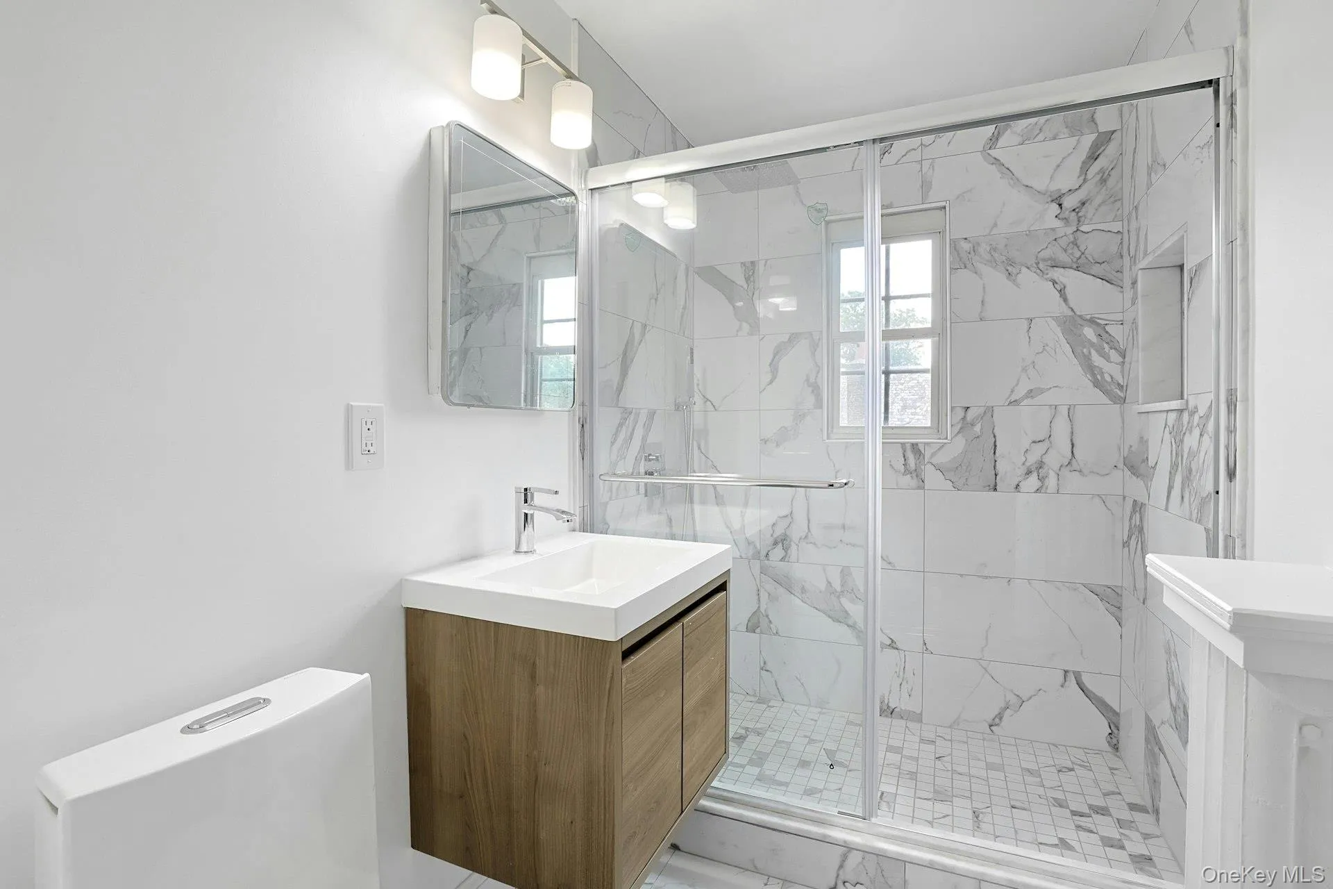Beautifully renovated with striking marble finishes, the third-floor hall bath features a spacious glass-enclosed shower, contemporary vanity, and elegant fixtures, providing a sophisticated retreat for family and guests alike. Beautifully renovated with striking marble finishes, the third-floor hall bath features a spacious glass-enclosed shower, contemporary vanity, and elegant fixtures, providing a sophisticated retreat for family and guests alike.