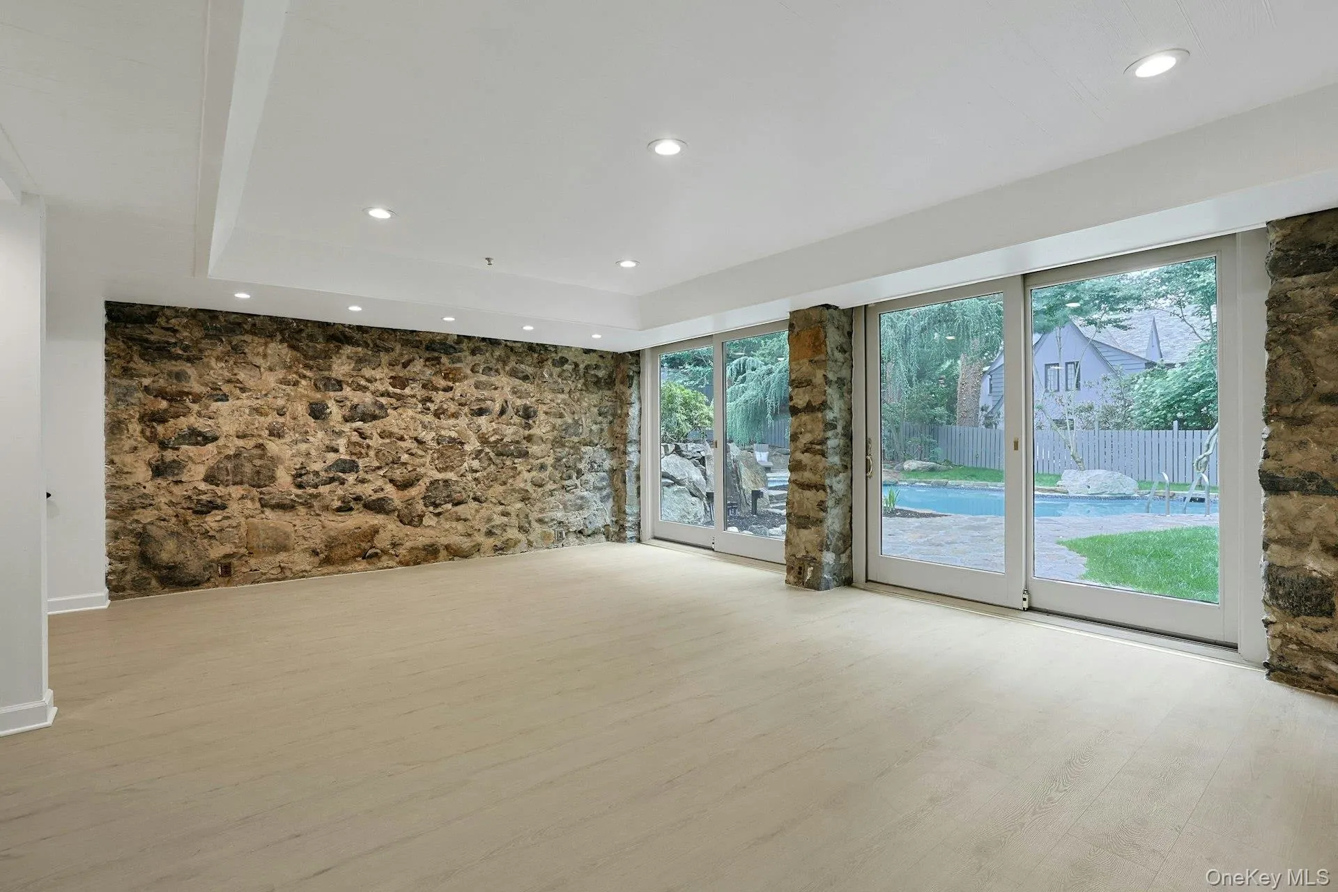 Designed for year-round enjoyment, this remarkable recreation room offers exceptional scale, original stone walls rich with character, and oversized sliding glass doors that blur the line between indoor and outdoor living. Designed for year-round enjoyment, this remarkable recreation room offers exceptional scale, original stone walls rich with character, and oversized sliding glass doors that blur the line between indoor and outdoor living.