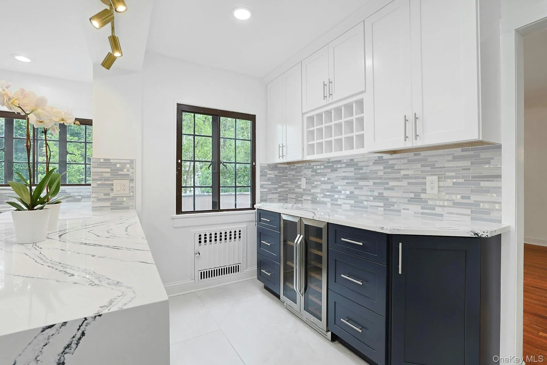 An elegant extension of the kitchen, the butler's pantry offers built-in wine storage, a wine refrigerator, and additional preparation and serving space for effortless entertaining. An elegant extension of the kitchen, the butler's pantry offers built-in wine storage, a wine refrigerator, and additional preparation and serving space for effortless entertaining.