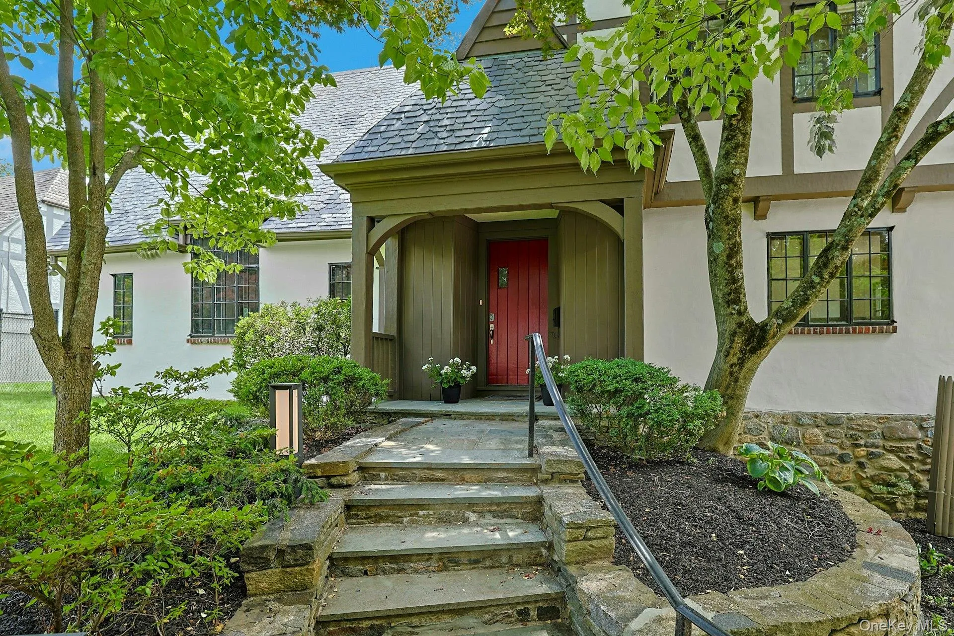 Beautiful stone steps, modern lighting, a wrought iron railing and lush plantings welcome you to this luxurious home, nestled in the heart of Edgemont's coveted Cotswolds neighborhood, blending timeless architectural charm with modern luxury. Beautiful stone steps, modern lighting, a wrought iron railing and lush plantings welcome you to this luxurious home, nestled in the heart of Edgemont's coveted Cotswolds neighborhood, blending timeless architectural charm with modern luxury.