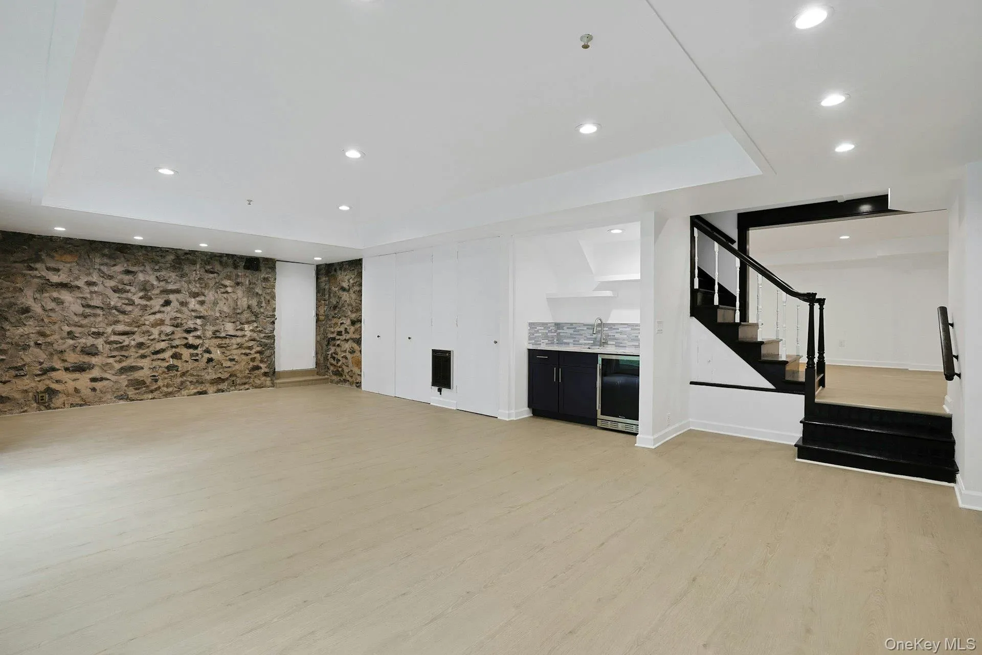 The extraordinary walk-out lower level offers exceptional space for recreation and entertaining, featuring a built-in kitchenette with bar sink and beverage refrigerator and abundant room to gather with family and friends. A large walk-in storage closet conceals a charming subterranean wine cellar, while direct access to the attached two-car garage adds everyday convenience. The extraordinary walk-out lower level offers exceptional space for recreation and entertaining, featuring a built-in kitchenette with bar sink and beverage refrigerator and abundant room to gather with family and friends. A large walk-in storage closet conceals a charming subterranean wine cellar, while direct access to the attached two-car garage adds everyday convenience.