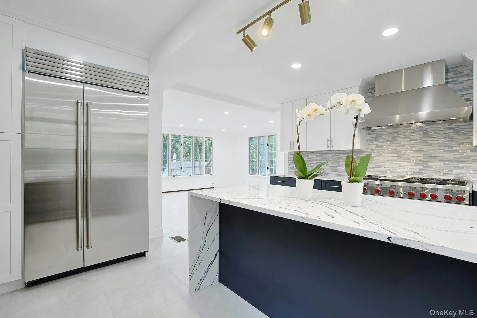 The oversized waterfall island serves as the centerpiece of this sophisticated kitchen, complemented by a Sub-Zero refrigerator/freezer and abundant space for gathering with family and friends. The oversized waterfall island serves as the centerpiece of this sophisticated kitchen, complemented by a Sub-Zero refrigerator/freezer and abundant space for gathering with family and friends.