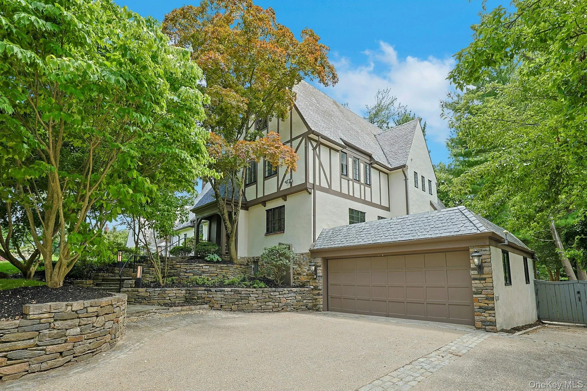 This impressive Tudor with a slate roof offers a two car attached garage with heated driveway, while the expansive roof deck above creates a unique outdoor retreat just steps from the kitchen. This impressive Tudor with a slate roof offers a two car attached garage with heated driveway, while the expansive roof deck above creates a unique outdoor retreat just steps from the kitchen.