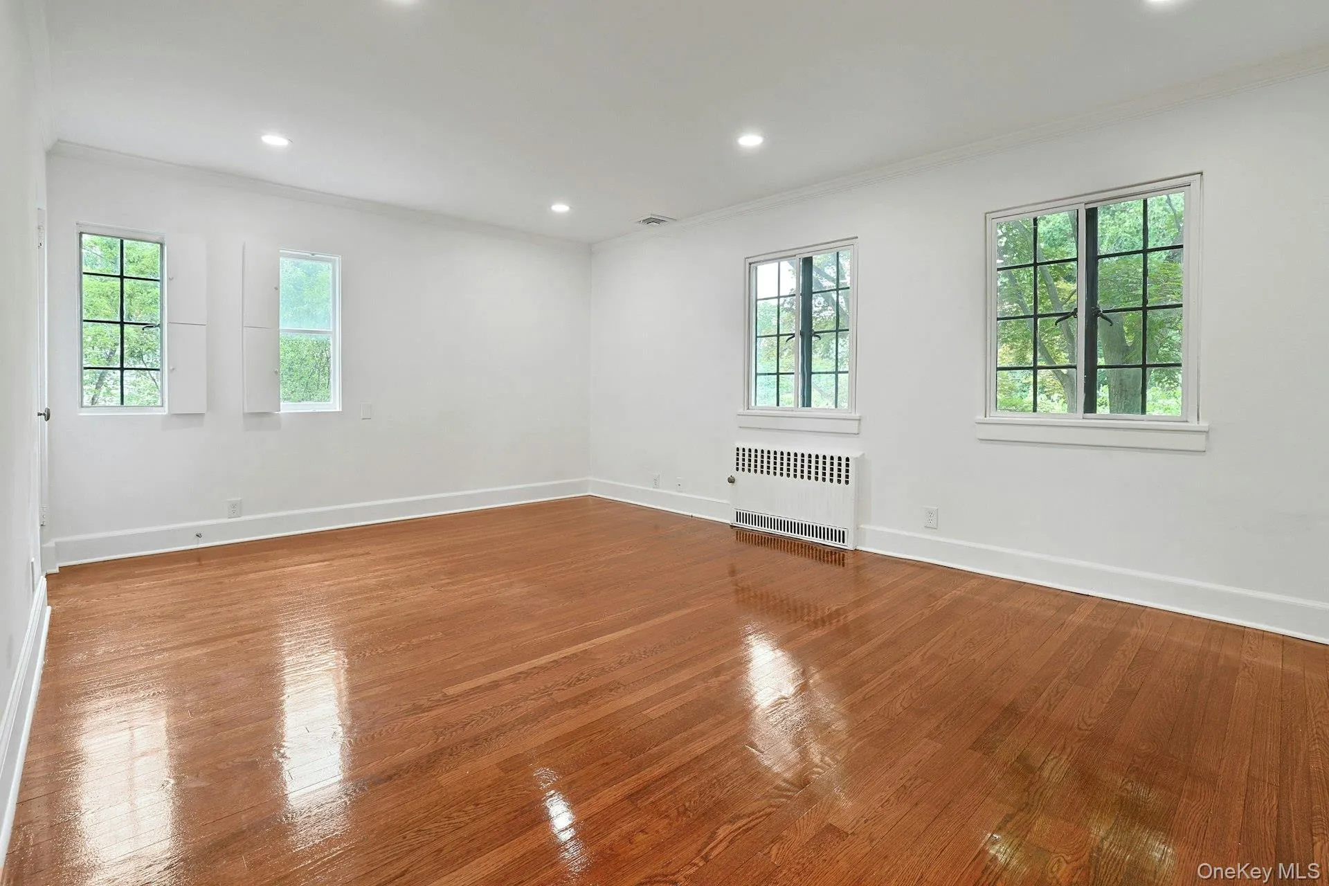 Bright and serene, the primary bedroom features generous proportions, recessed lighting, multiple closets, and a renovated ensuite bath, creating a private sanctuary within the home. Bright and serene, the primary bedroom features generous proportions, recessed lighting, multiple closets, and a renovated ensuite bath, creating a private sanctuary within the home.