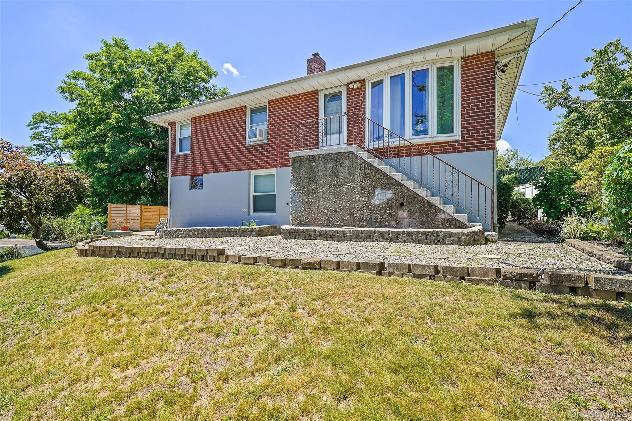 Front view of house with sloped yard. Front view of house with sloped yard.