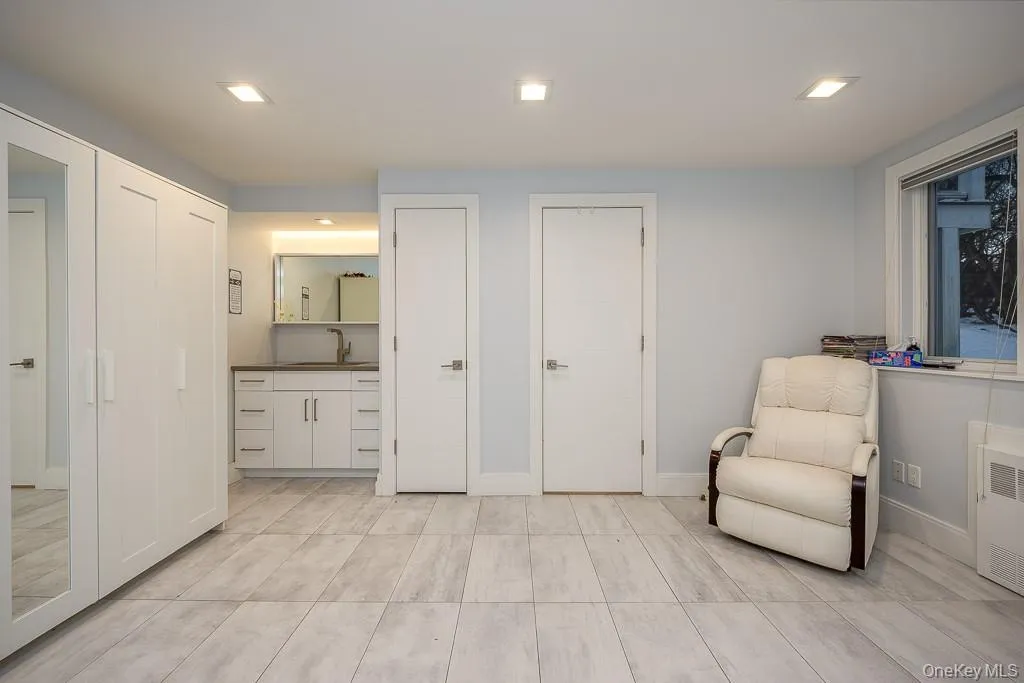Sitting room featuring recessed lighting and radiator Sitting room featuring recessed lighting and radiator