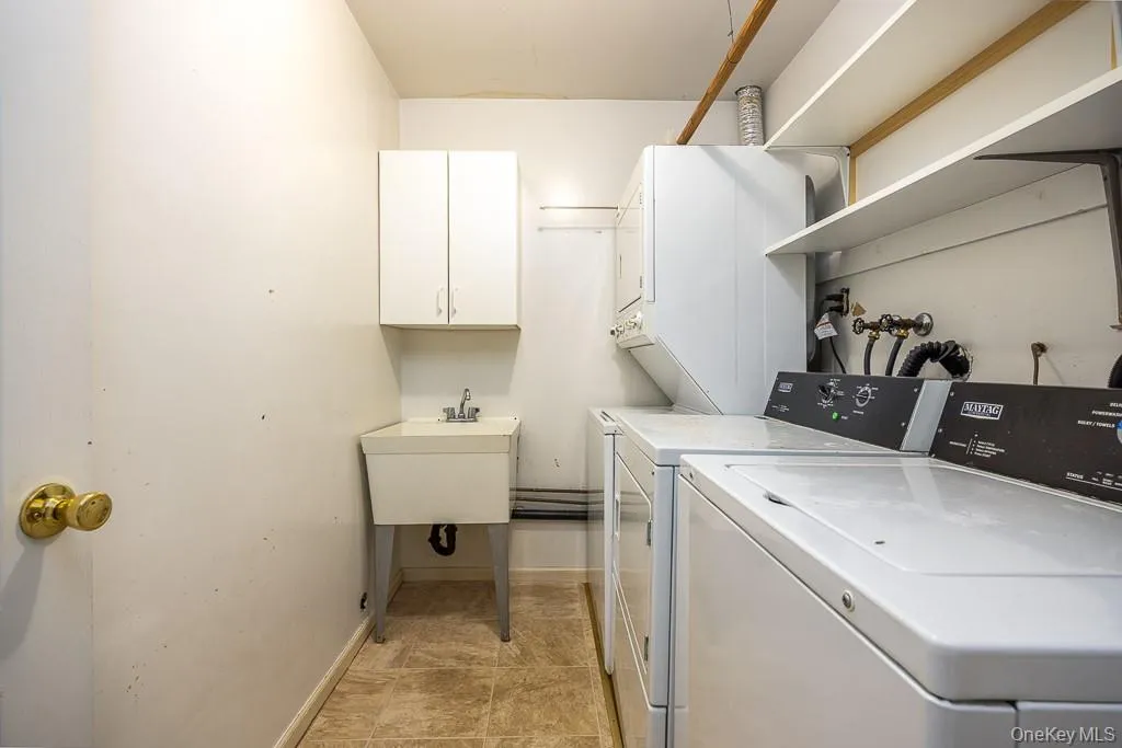 Washroom with estacked washer and dryer and baseboards Washroom with estacked washer and dryer and baseboards