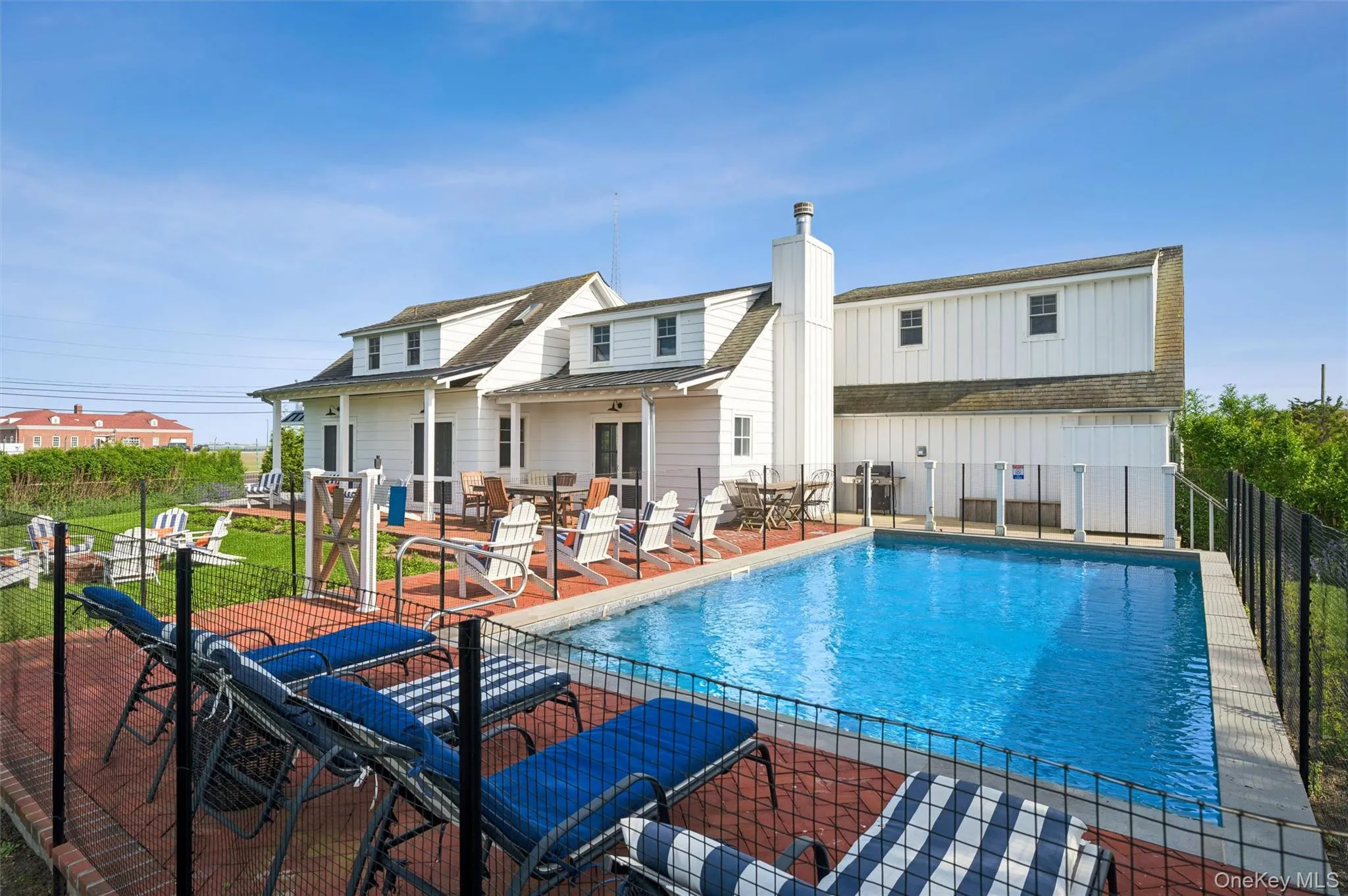 Summer entertaining area with patios for dining and relaxing, outdoor shower, and pool. Summer entertaining area with patios for dining and relaxing, outdoor shower, and pool.
