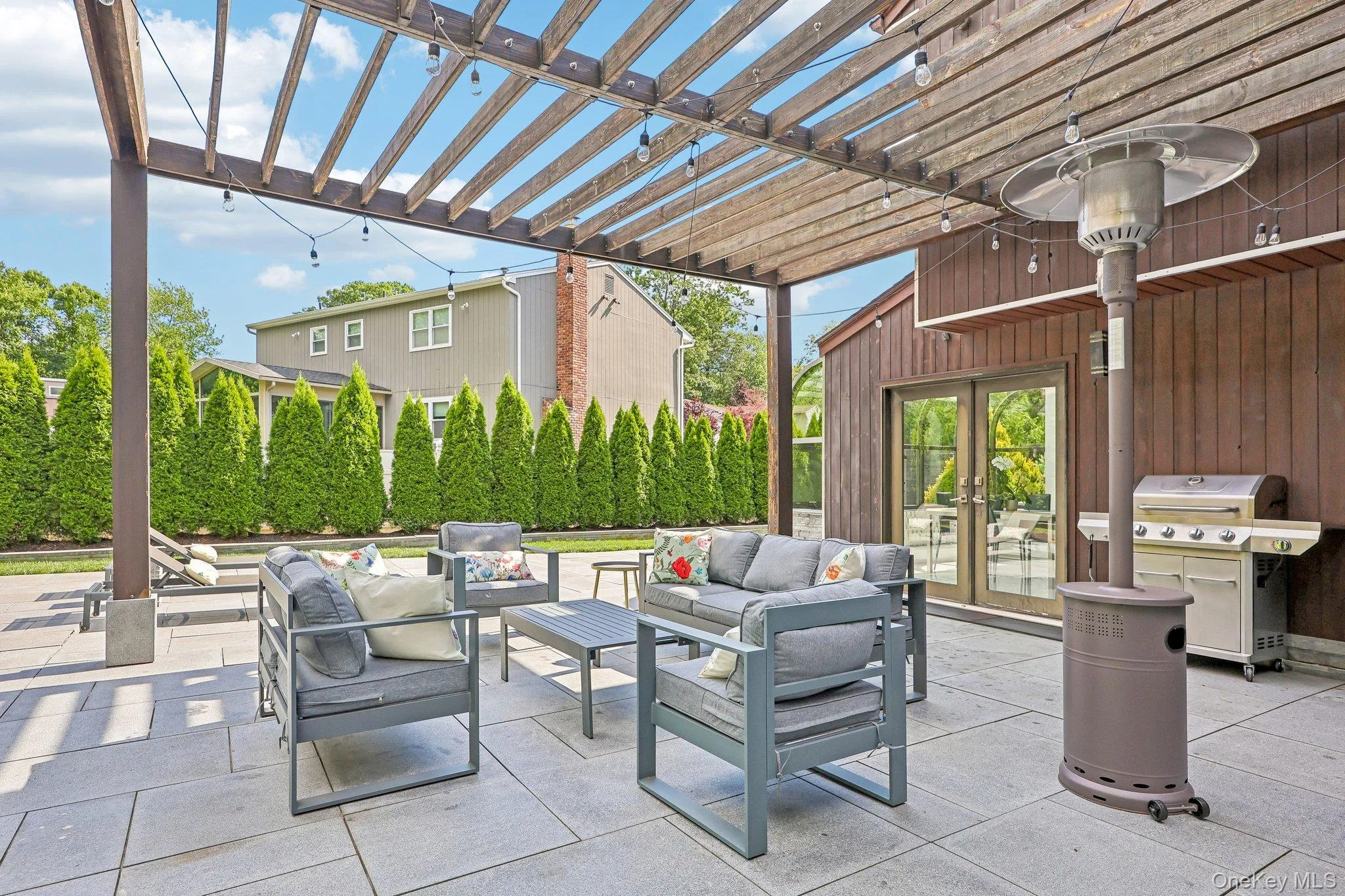 Alternative view of granite patio. Double doors lead to kitchen. Outdoor furniture, new outdoor heat lamp, gas grill and retro lights are included Alternative view of granite patio. Double doors lead to kitchen. Outdoor furniture, new outdoor heat lamp, gas grill and retro lights are included