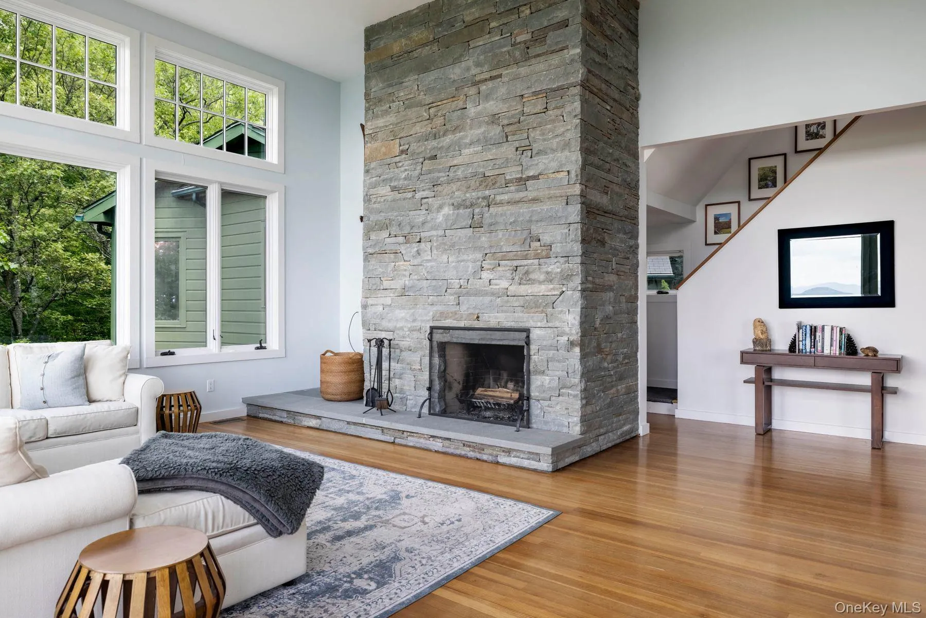 Living room featuring cathedral ceilings and bluestone fireplace. Living room featuring cathedral ceilings and bluestone fireplace.