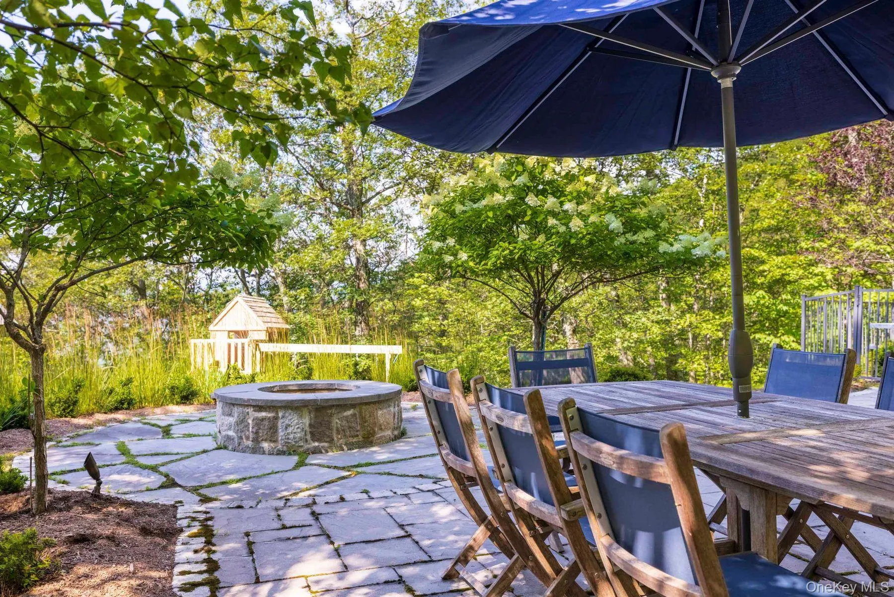 View of patio with a fire pit and outdoor dining space View of patio with a fire pit and outdoor dining space