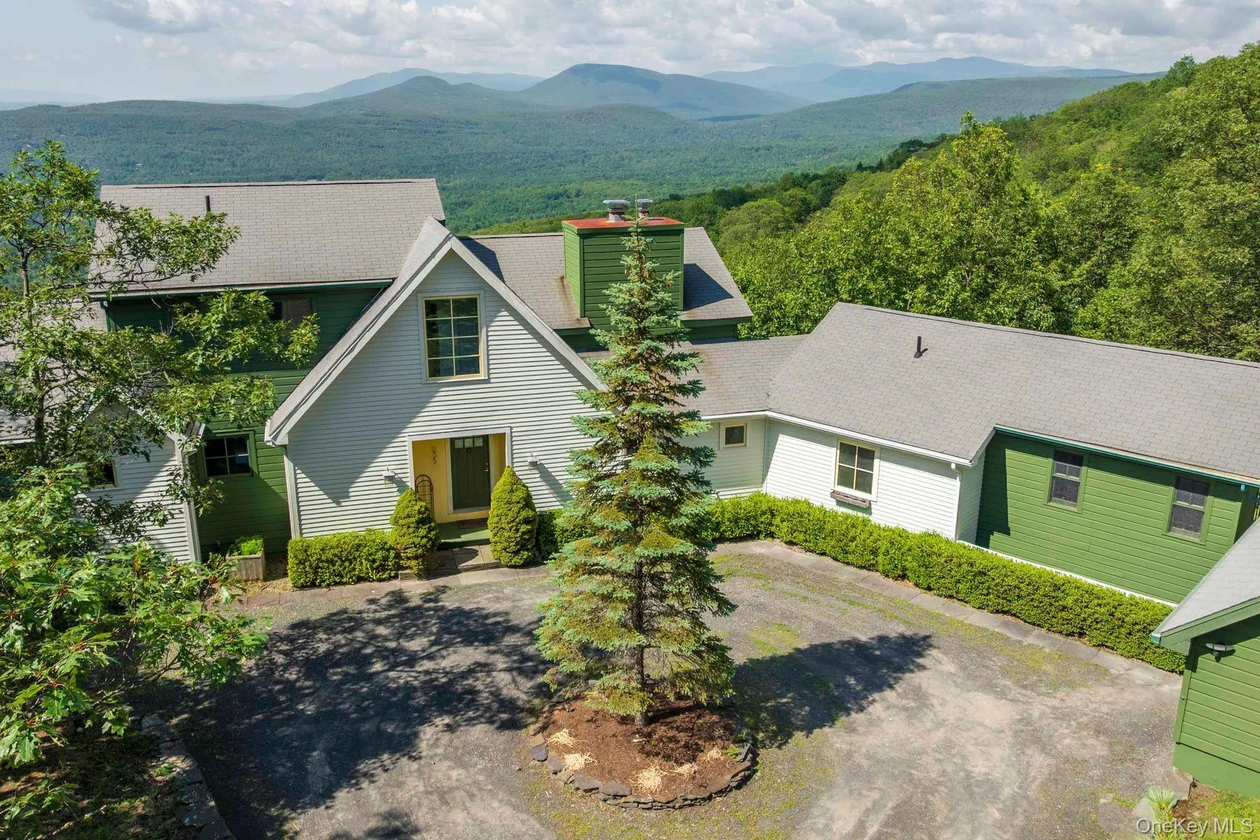 View of front of home with a mountain view and circular driveway. View of front of home with a mountain view and circular driveway.