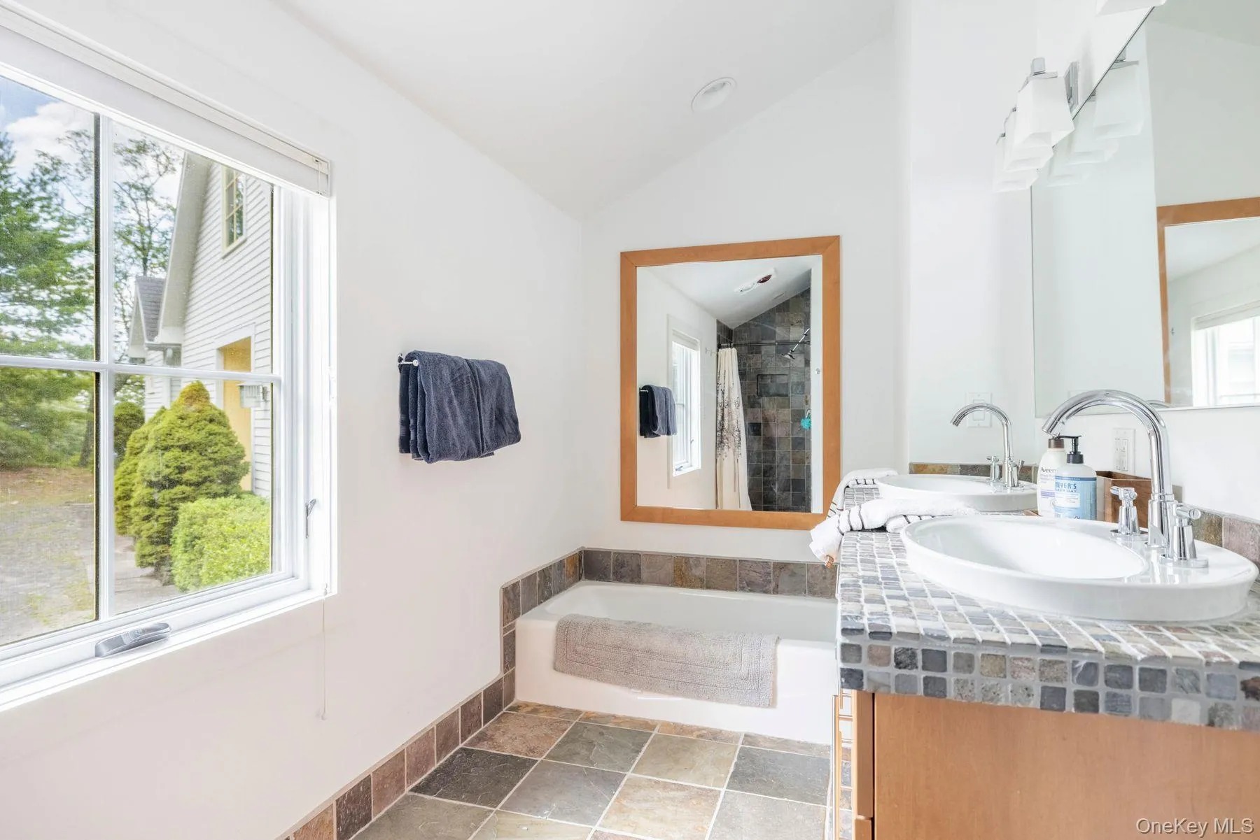 Primary ensuite with double vanity, bathtub, and shower Primary ensuite with double vanity, bathtub, and shower