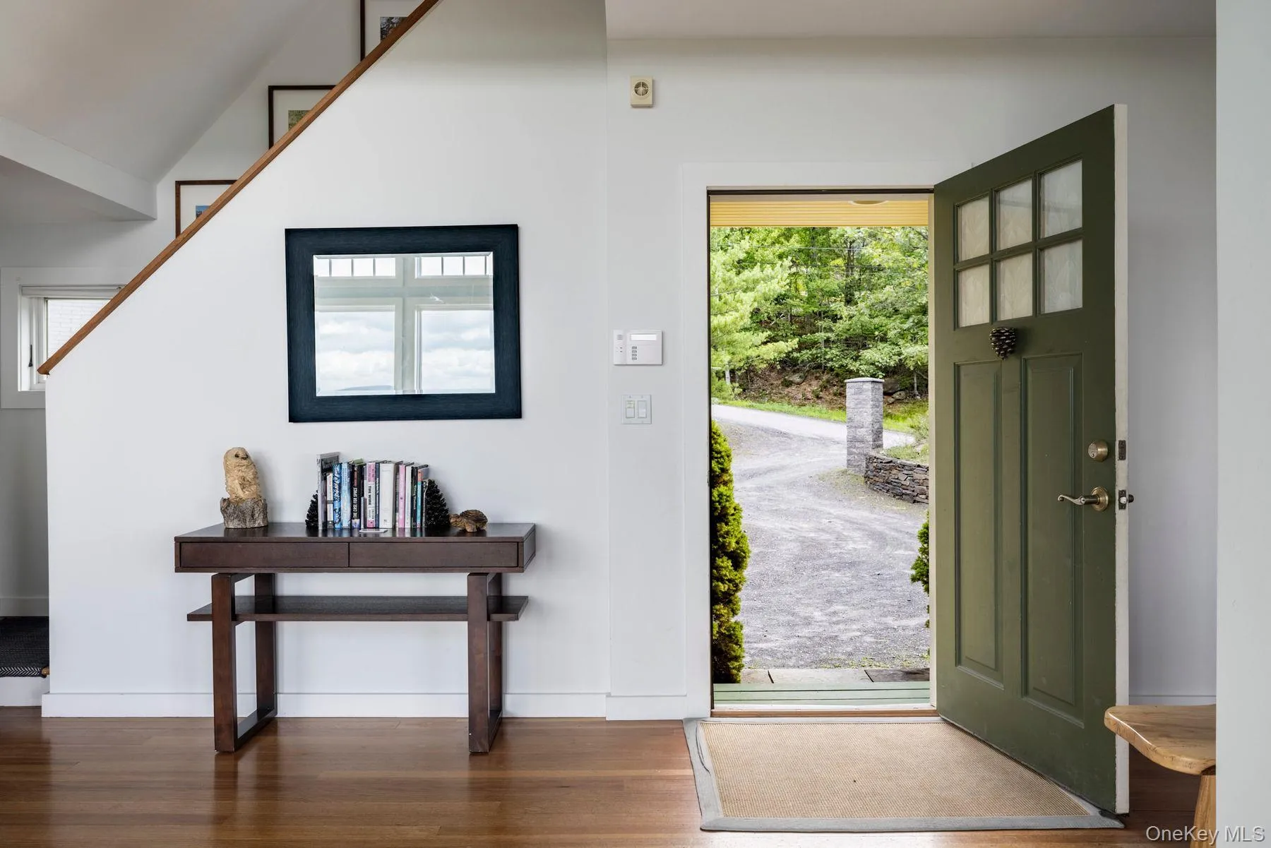 Foyer entrance featuring healthy amount of natural light and wood finished floors Foyer entrance featuring healthy amount of natural light and wood finished floors
