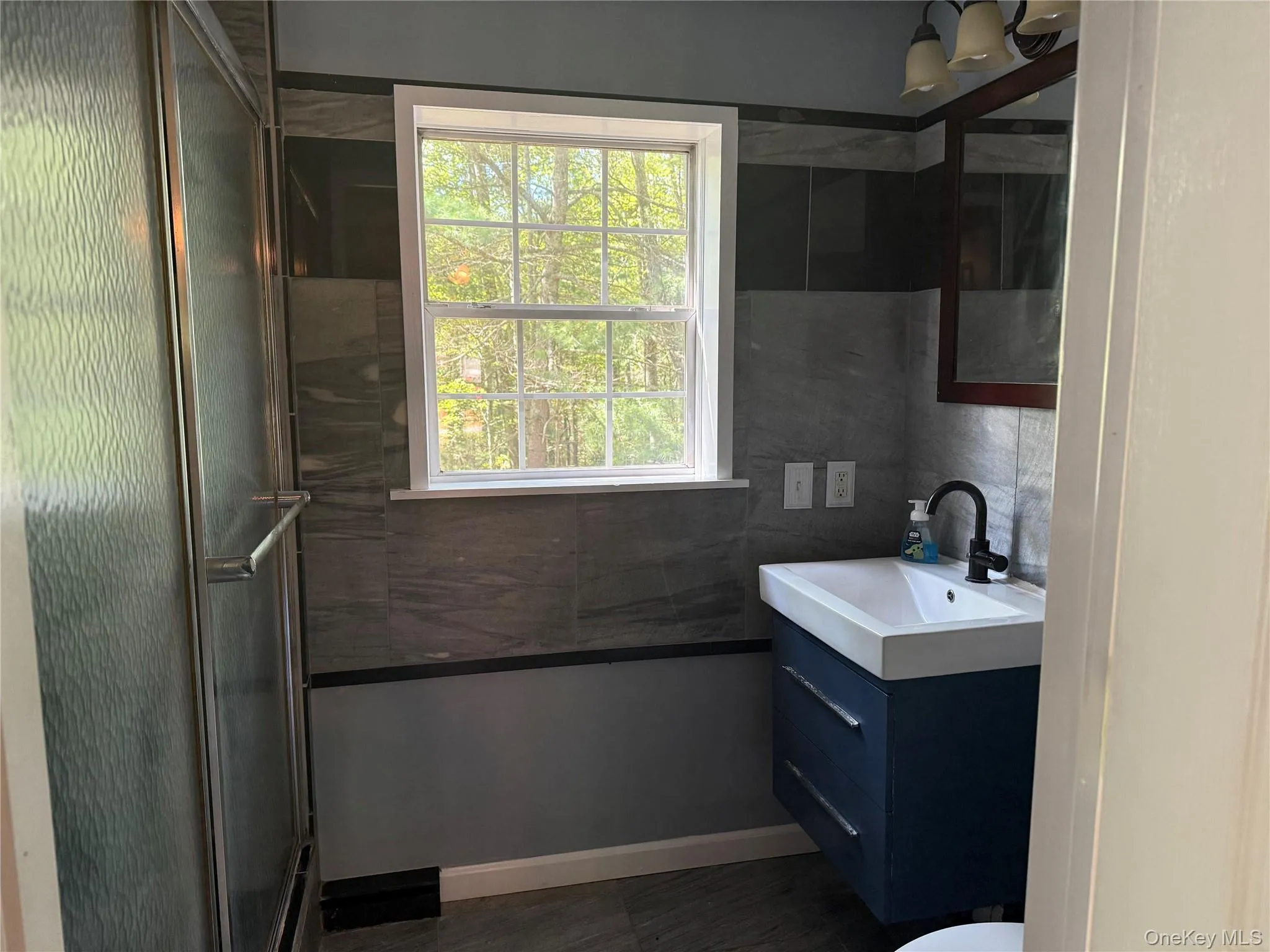 Full bath with vanity and a shower stall Full bath with vanity and a shower stall