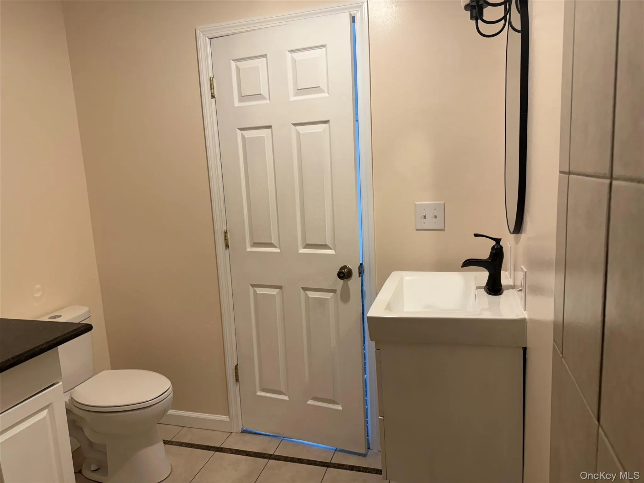 Bathroom with vanity and light tile patterned floors Bathroom with vanity and light tile patterned floors