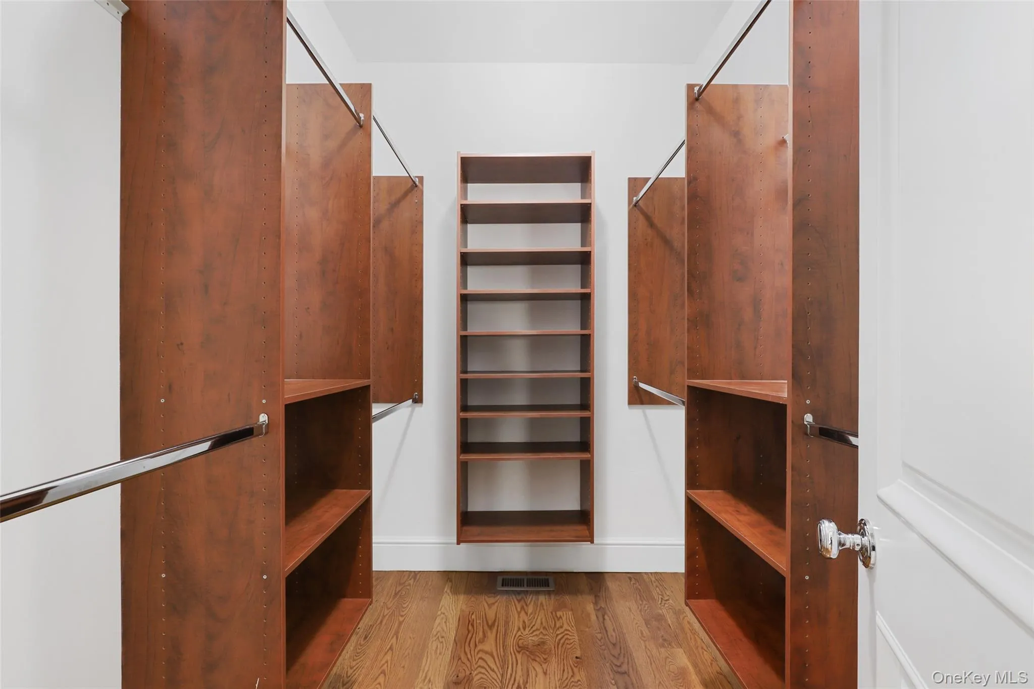 walk-in primary closet hardwood walk-in primary closet hardwood