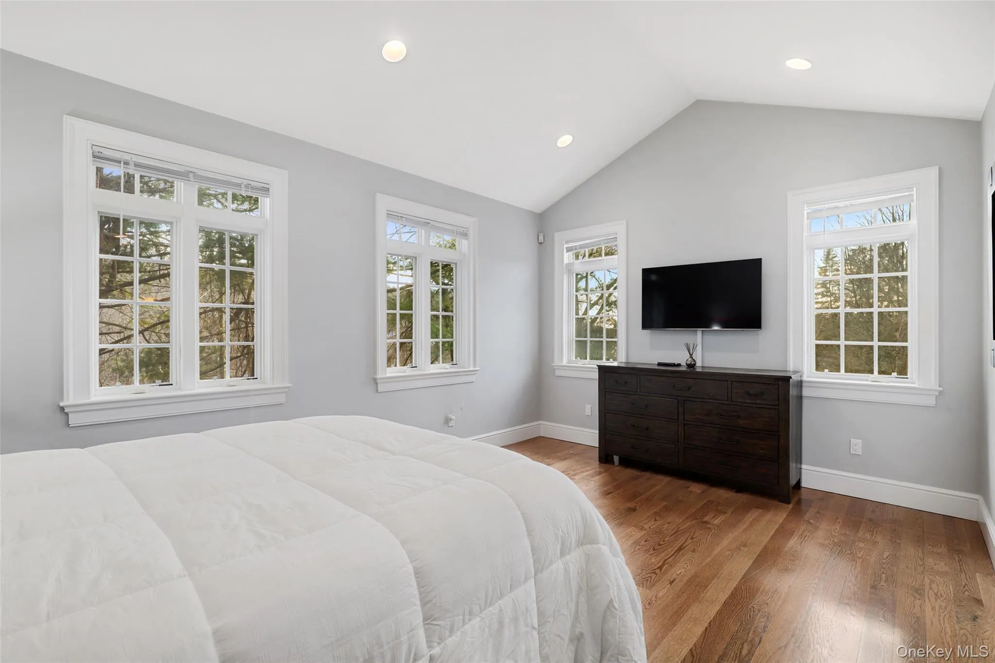 Main Floor Primary Bedroom featuring vaulted ceiling Main Floor Primary Bedroom featuring vaulted ceiling