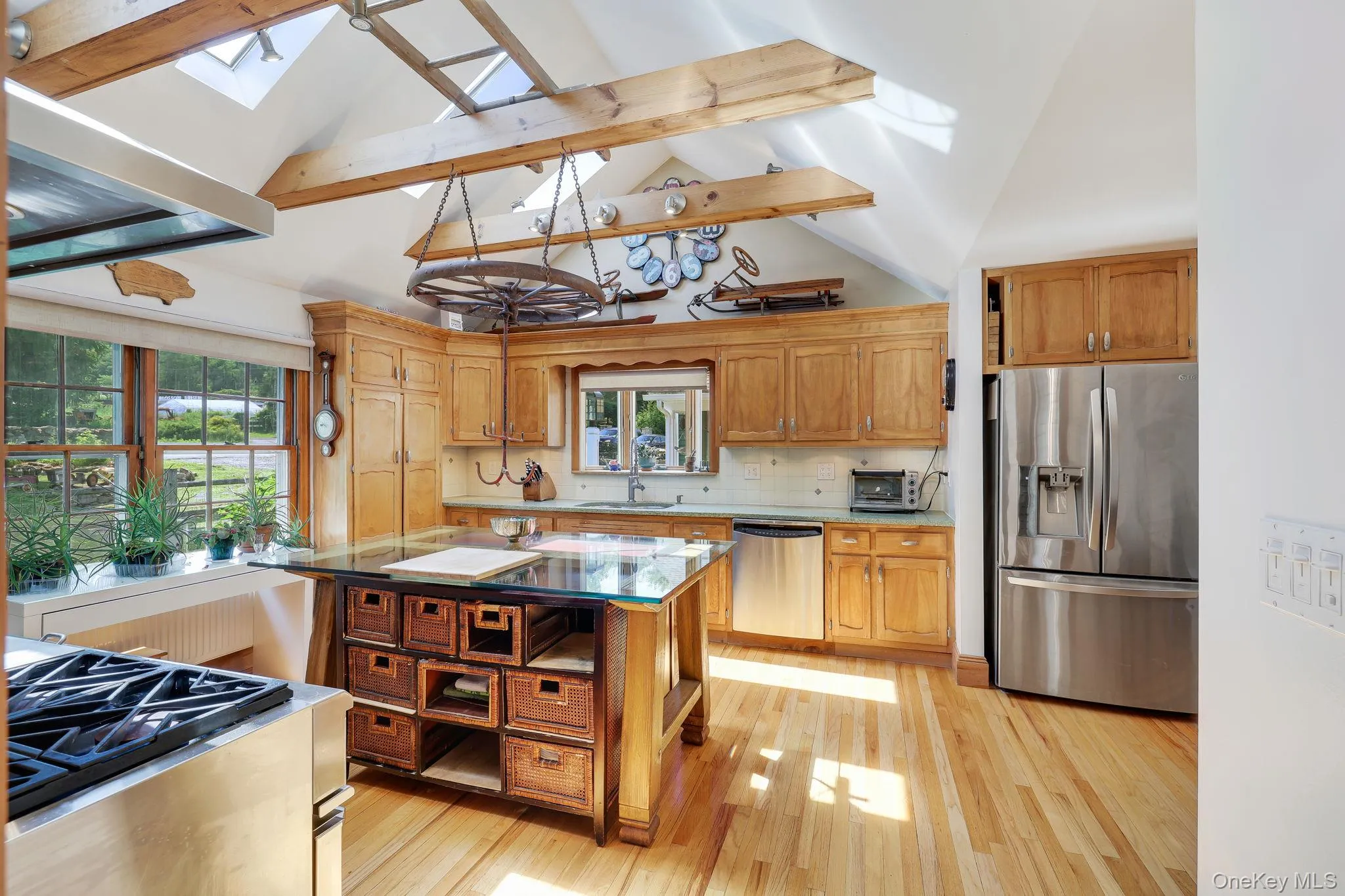 Kitchen with vaulted ceilings, exposed wood beams and skylights. Kitchen with vaulted ceilings, exposed wood beams and skylights.